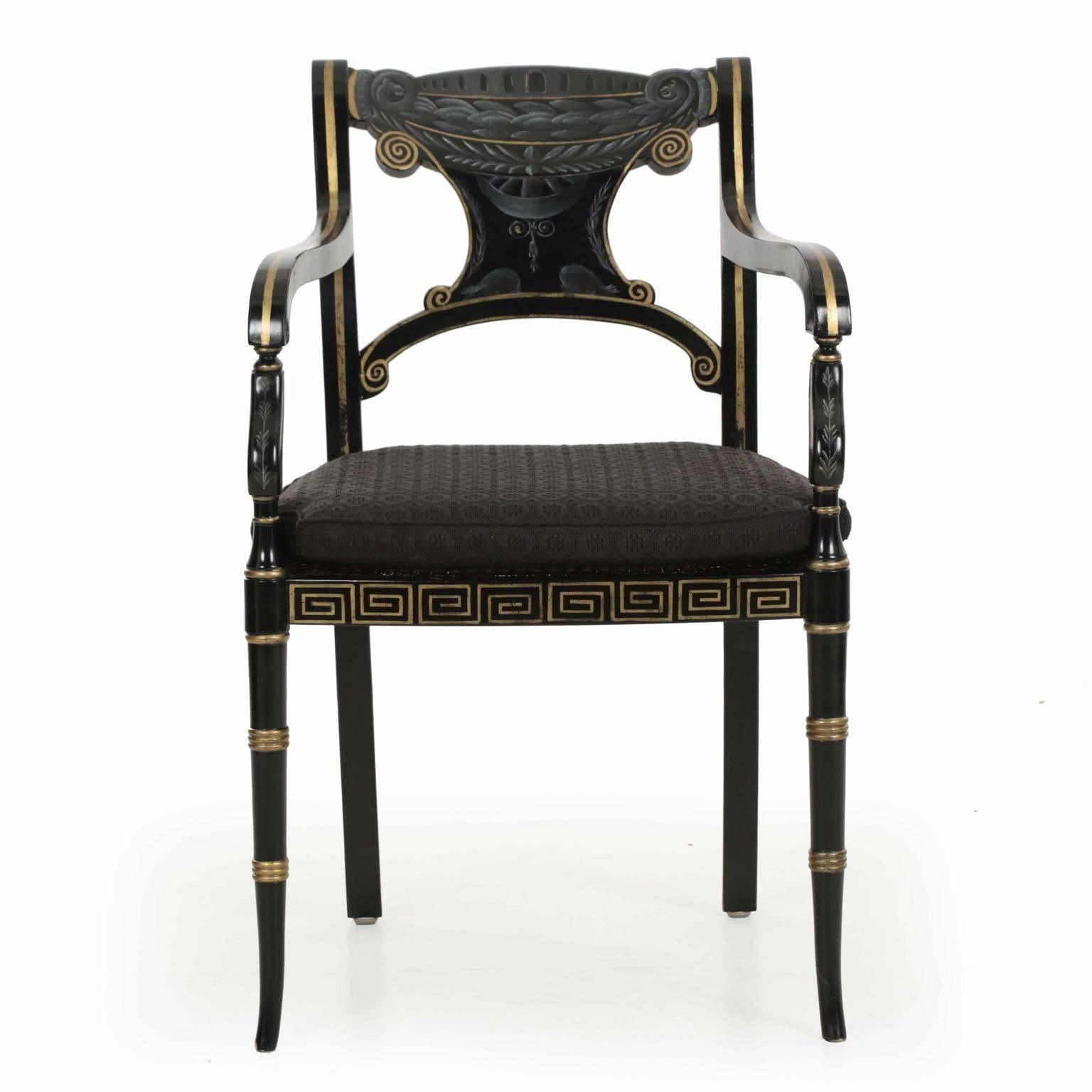 This gorgeous Regency style ebonized and parcel-gilt highlighted painted armchair is a very picture of Classicism. We acquired these as a set of six, but they make such incredibly striking desk chairs and accents in pairs that they are being sold