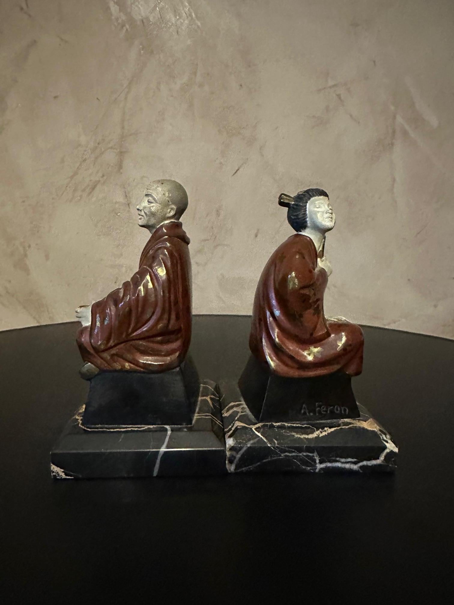 Pair of painted spelter bookends on a marble base dating from the 1930s representing a monk and a geisha. Adam Feron signature on each character.
Paint faded in some places but overall good condition.
Nice quality.