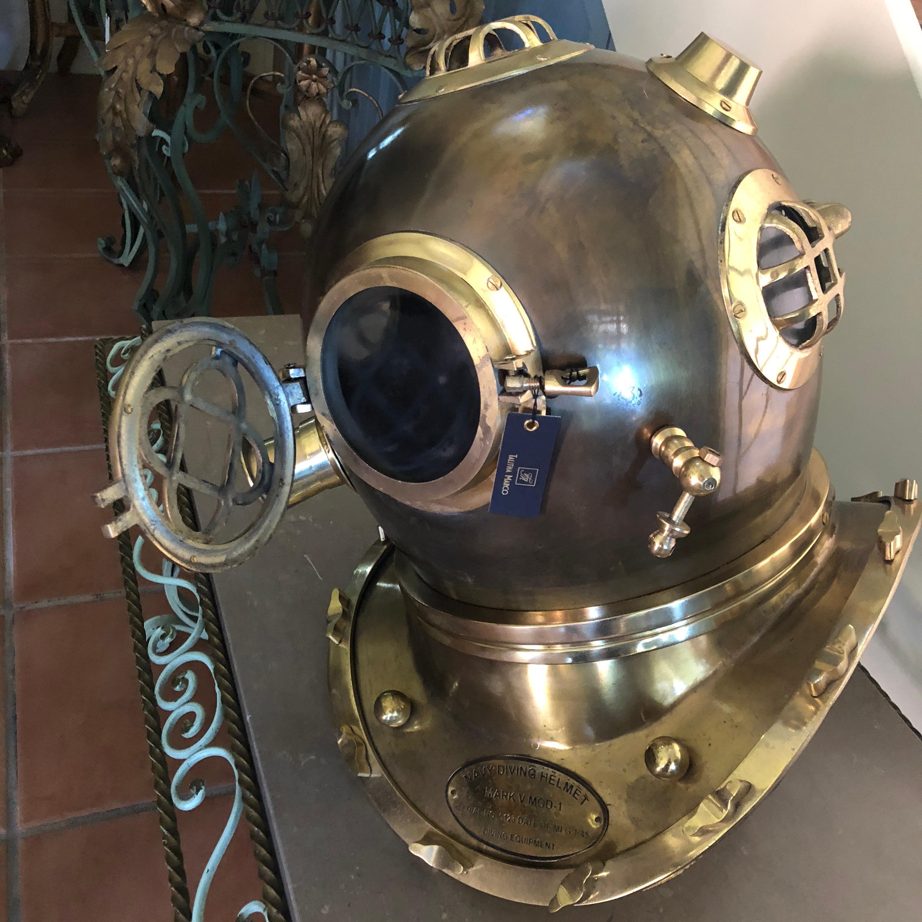 A beautiful decorative piece suitable for a nautical themed pool house or stylish office. This American Navy Diving Helmet, is a Mark V 20th century reproduction, featuring brass casing with bronze adornments. This helmet is a beautiful condition
