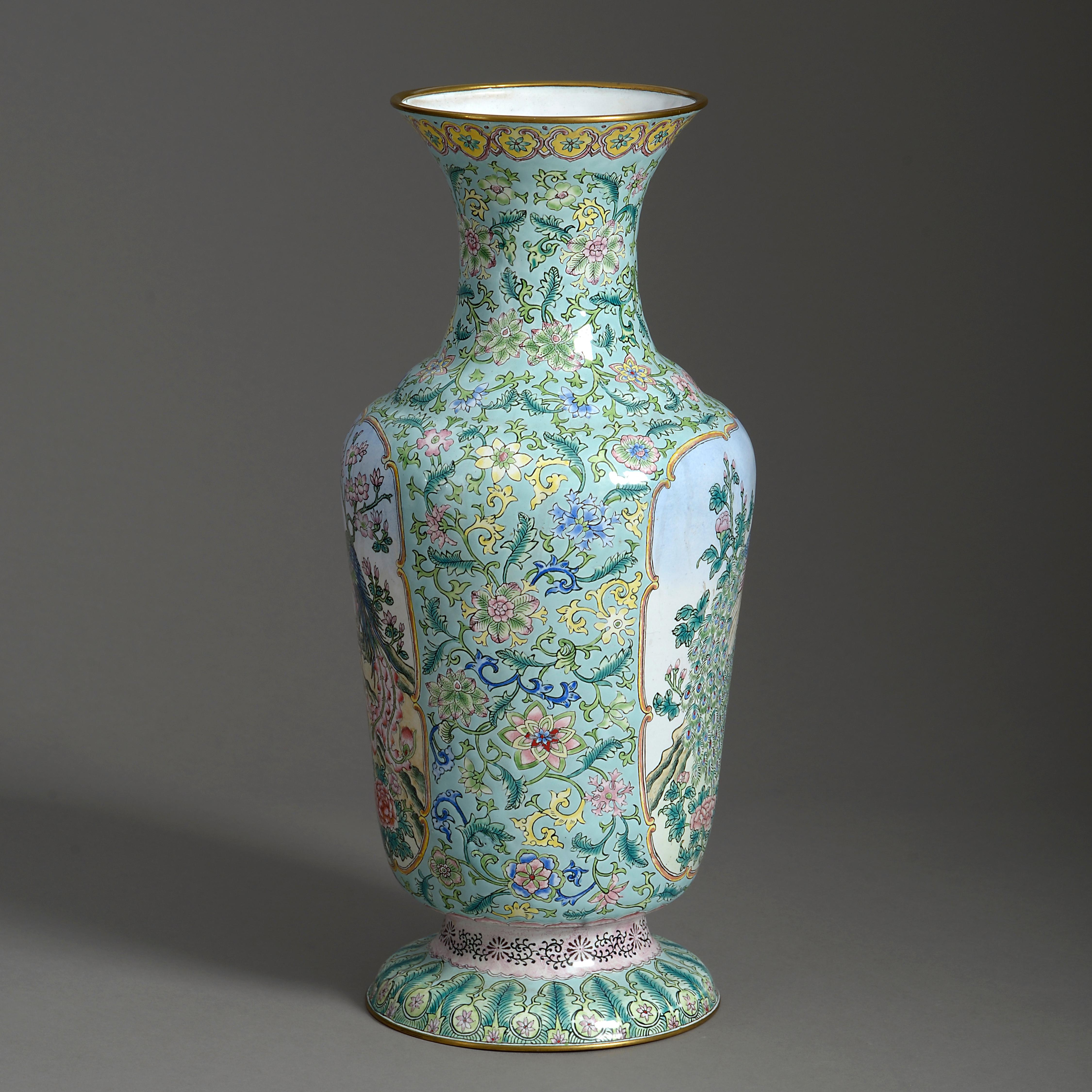 A mid-20th century republic period canton enamel vase of good scale, decorated in polychrome glazes with scrolling foliage upon a turquoise ground, the cartouches with stylised peacocks.

   