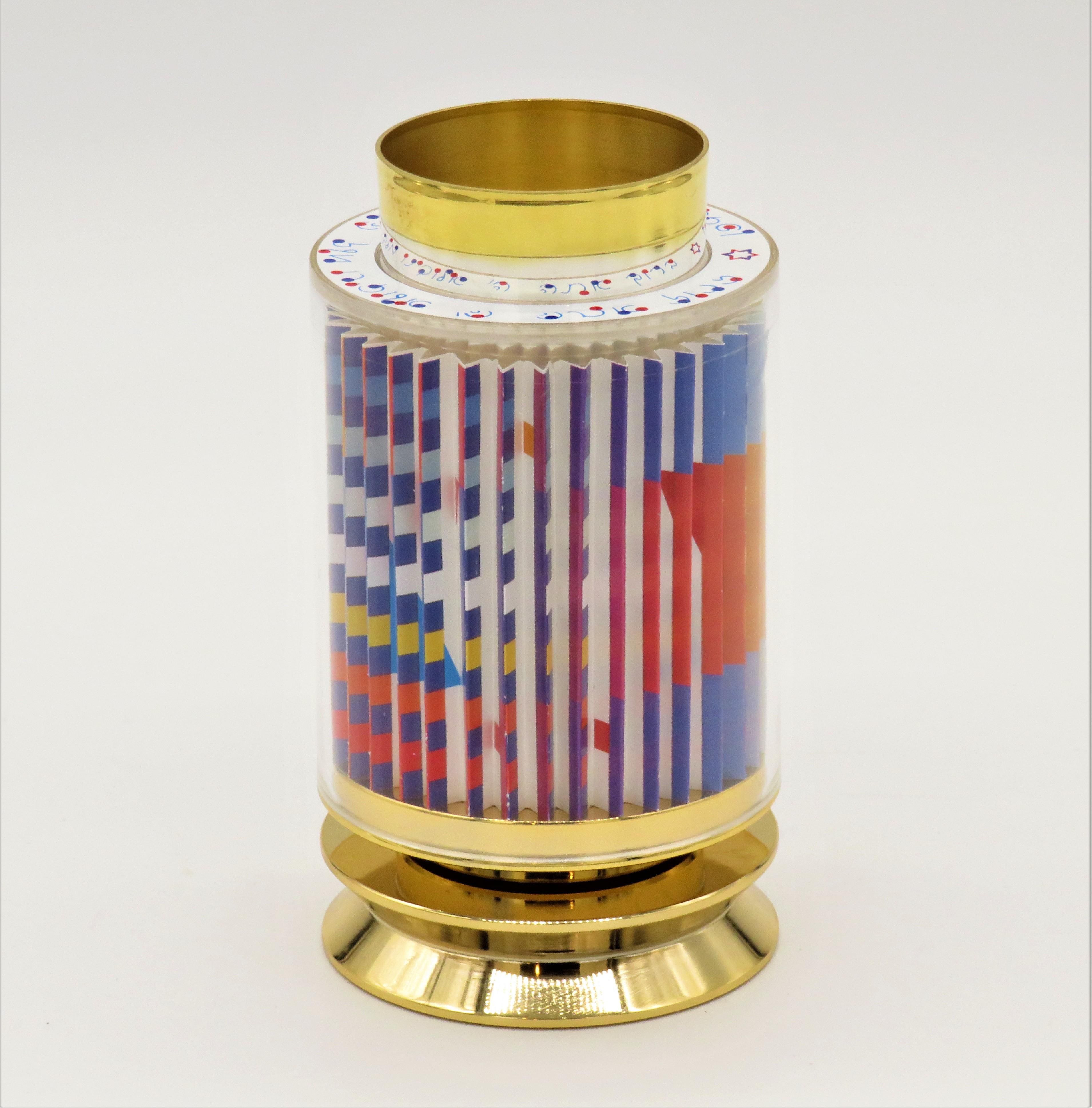925 sterling silver kiddush cup with 24k gold plated which fits inside the revolving Agam serigraph contained in the lucite cylinder. This cup can be spun to see the star of David magically appear. Agam's own Hebrew typography is imprinted on top of