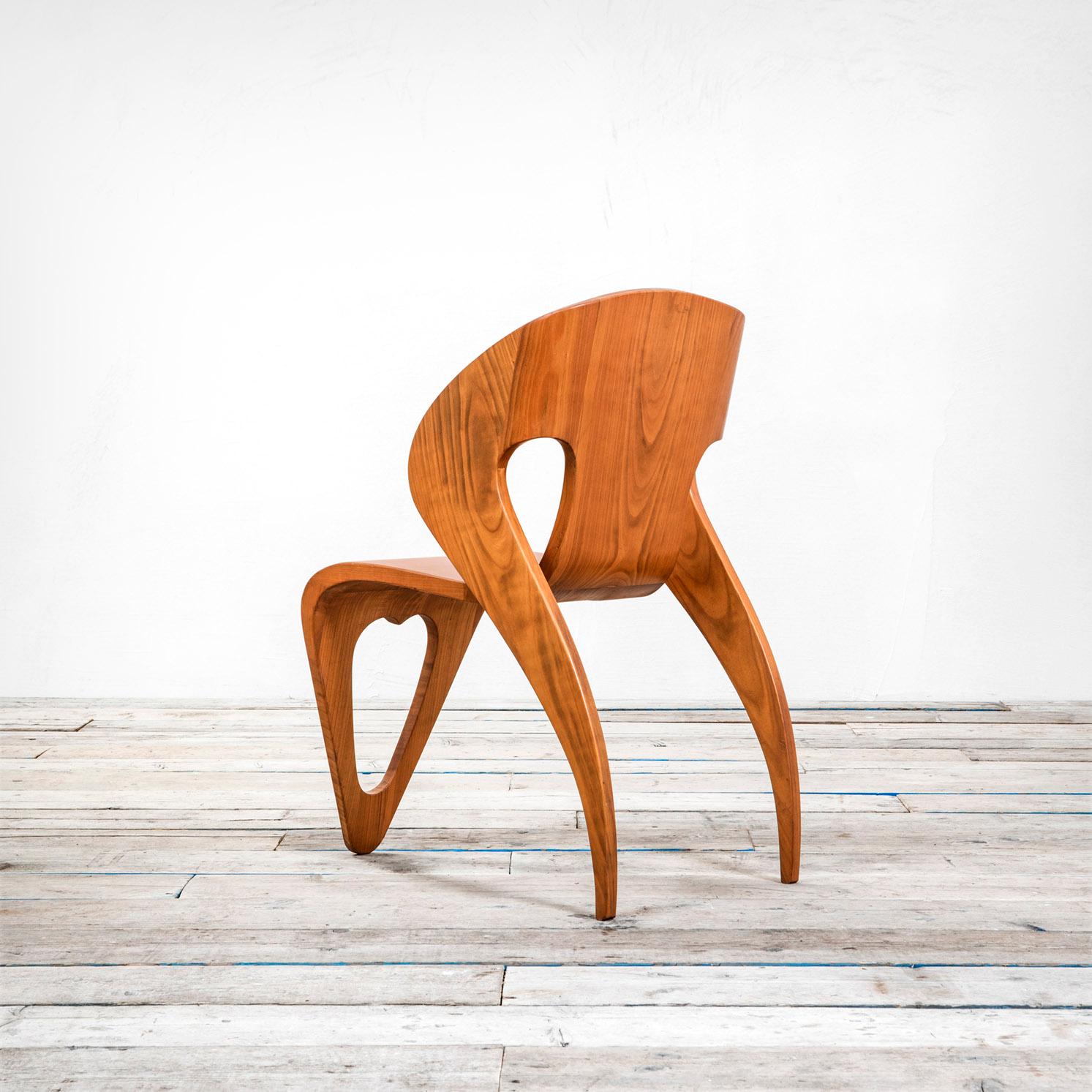This very peculiar chair was designed by the couple of Turin Architects Roberto Gabetti and Mario Roggero at the end of '40s. This chair was designed for a project of design of Rooms' Hotel. 
The chair is meant as a unique piece of curved solid
