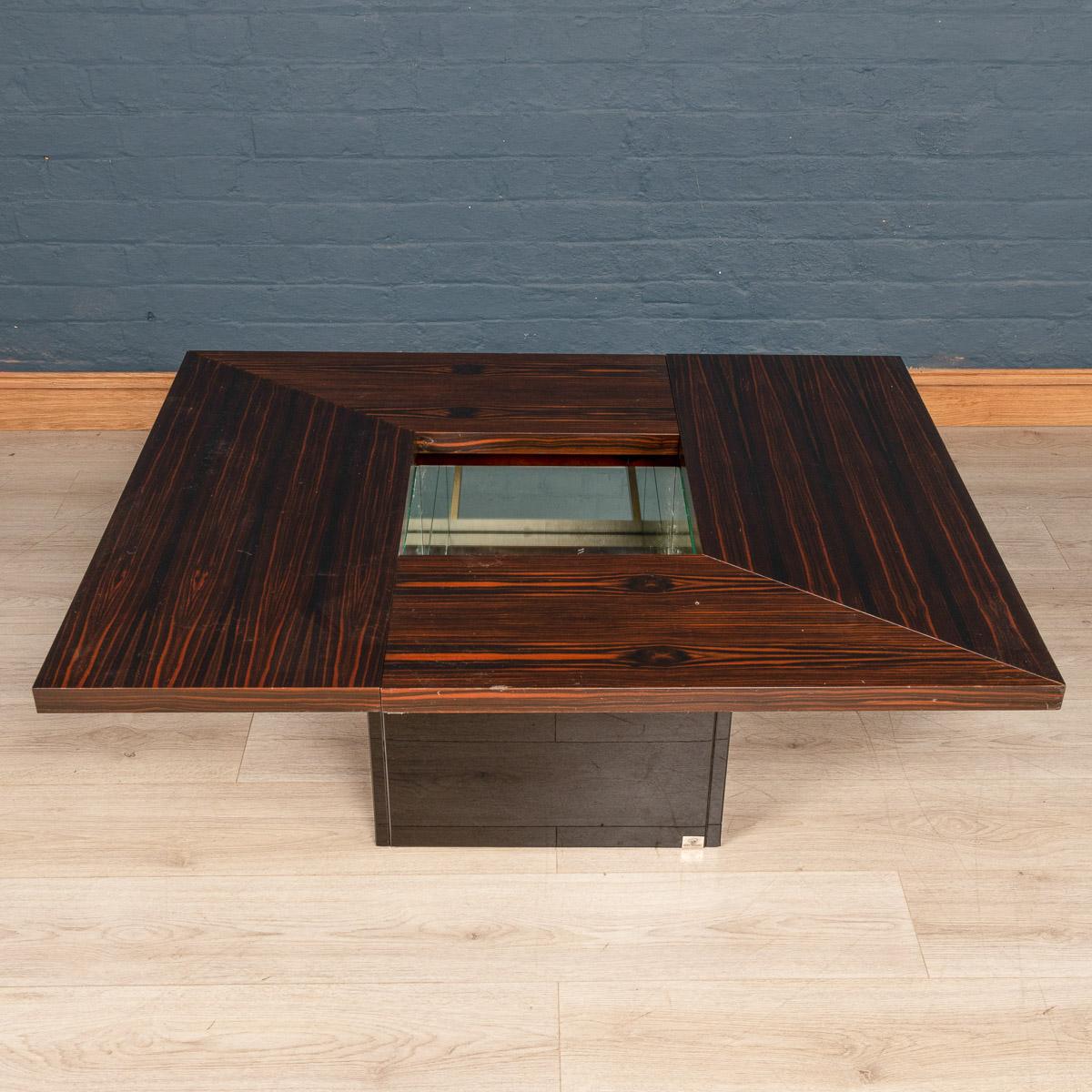 A stylish 1970s mid-century coffee table and dry cocktail bar designed by Paul Michel for the luxury interiors brand Roche Bobois. An exotic wood veneer finishes the table top and pops out wonderfully against the high gloss black laminate