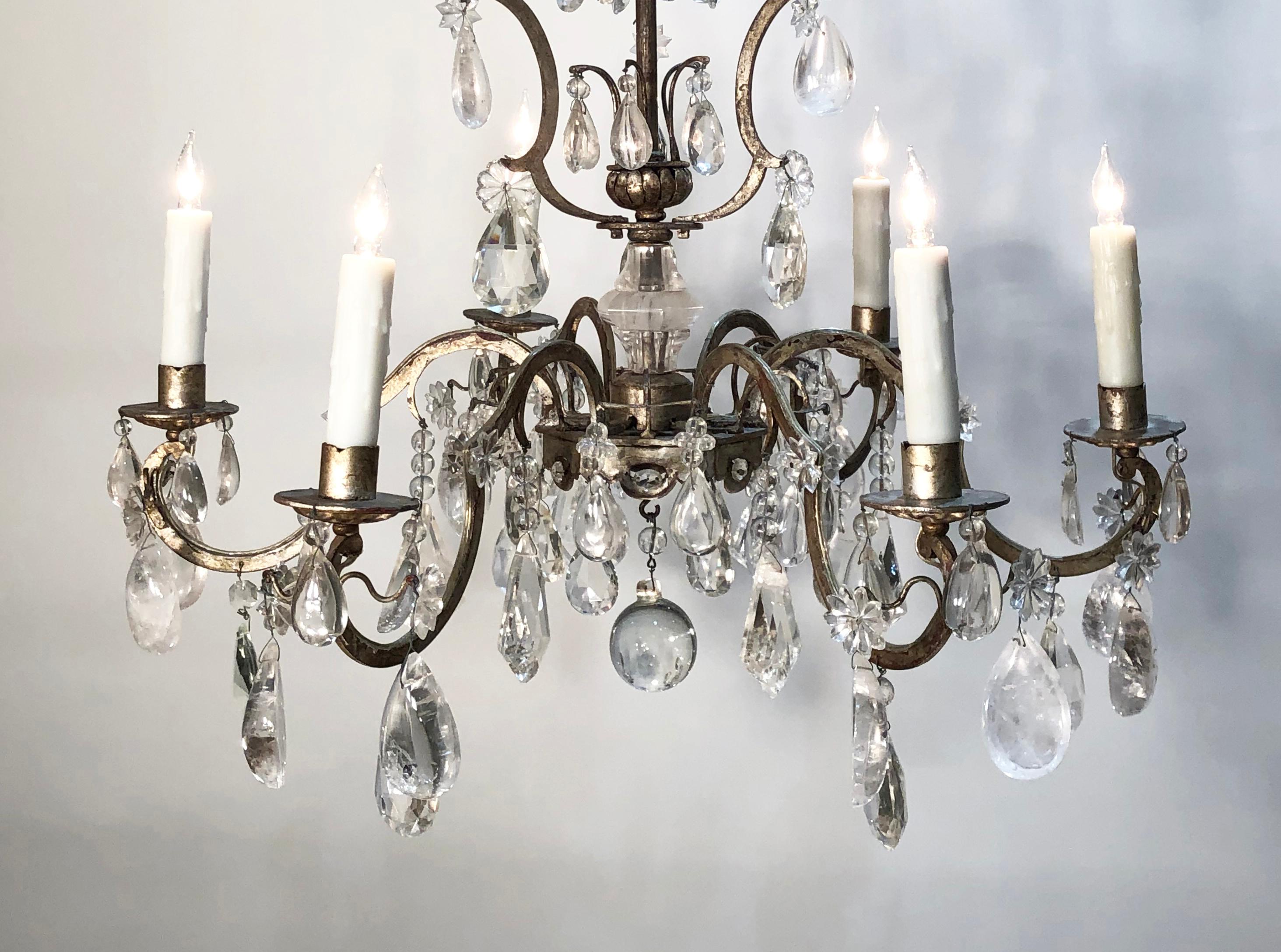 Elegant mid-20th century rock crystal and silver leaf Italian chandelier. This rock crystal and silver leaf chandelier is in the 18th century chinoiserie style. The chandelier frame is steel with silver leaf and is adorned with rock crystal pendants.