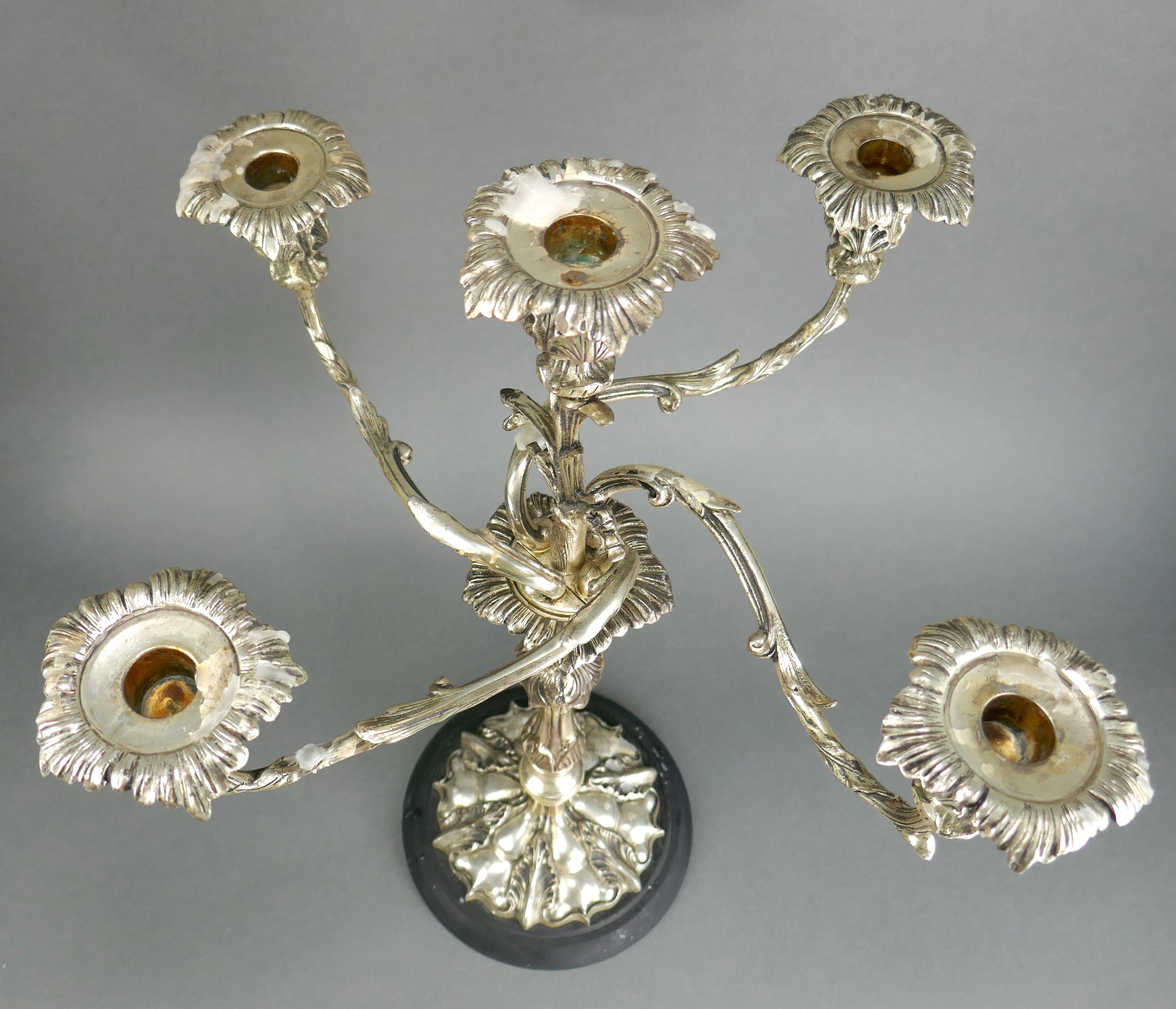 Large single centerpiece silver-plate candelabra. It dates to the 1960s and shows wax residue from use (seen in the images). 