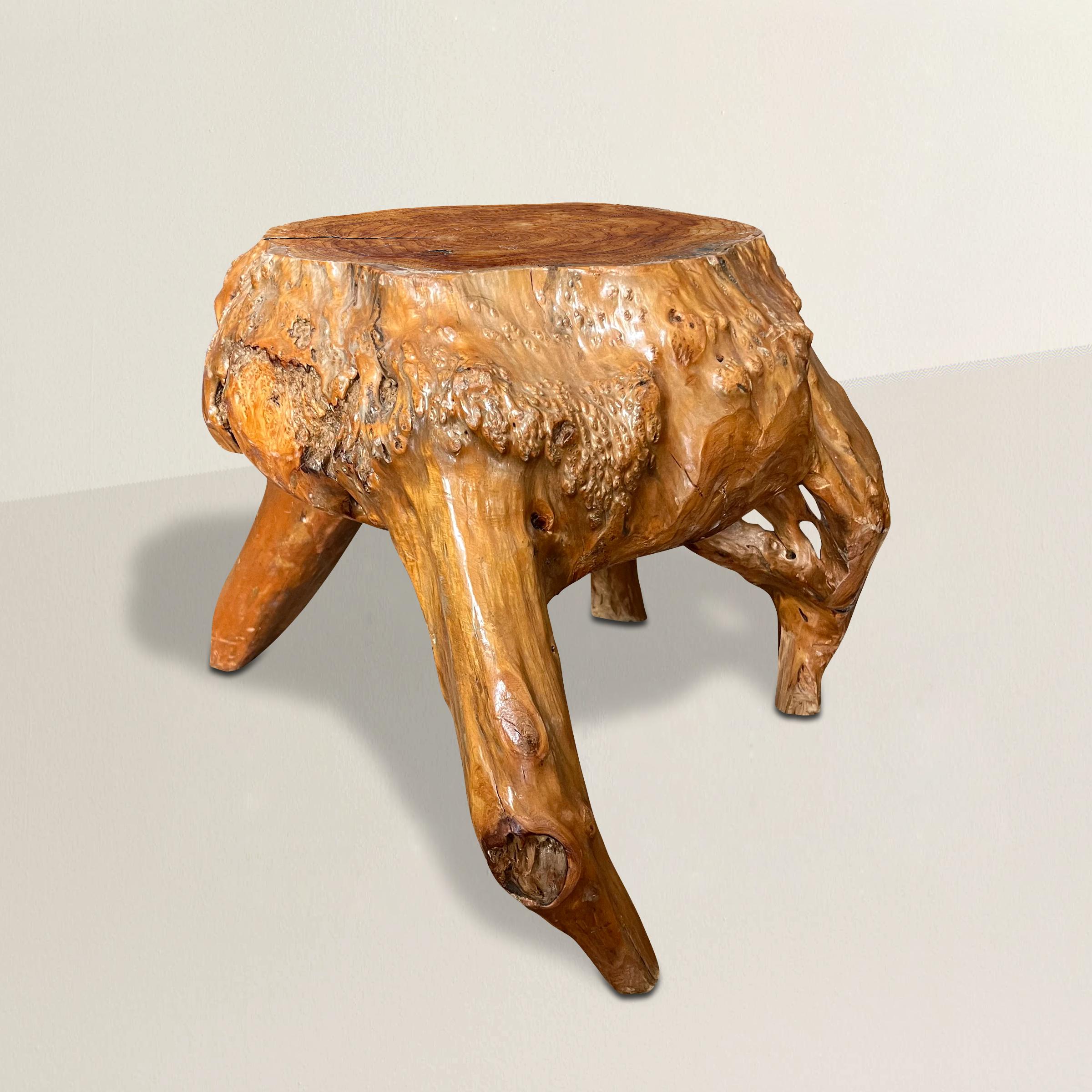 A striking and animated 20th century root wood stool with four snarled legs supporting a squatty burled top, and with a wonderful glowing patina. The perfect extra seat for unexpected guests, or a perch for a cocktail or book next to your favorite