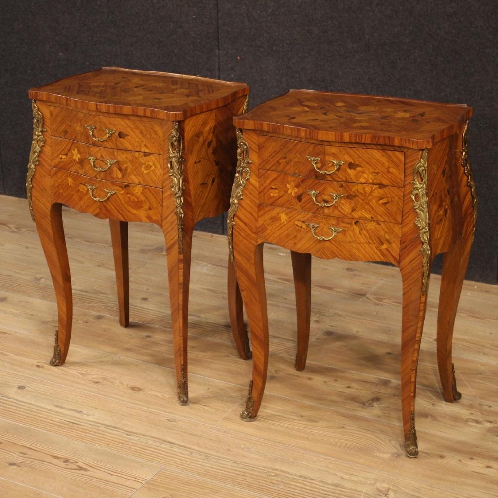 Pair of French bedside tables from 20th century. Furniture richly inlaid in woods of rosewood, maple, boxwood, mahogany and fruitwood with decorations and handles in gilded and chiseled bronze. Small night stands equipped with wooden tops in
