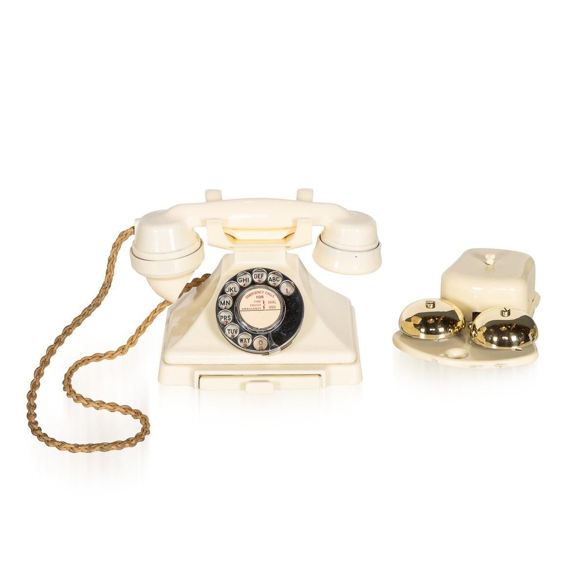 A superb 20th Century rotary Bakelite telephone and bell system. The phone features the original cord connecting handset to reciever and a small drawer at the front revealing a pad for telephone numbers. There is a bell sysem which can be attached