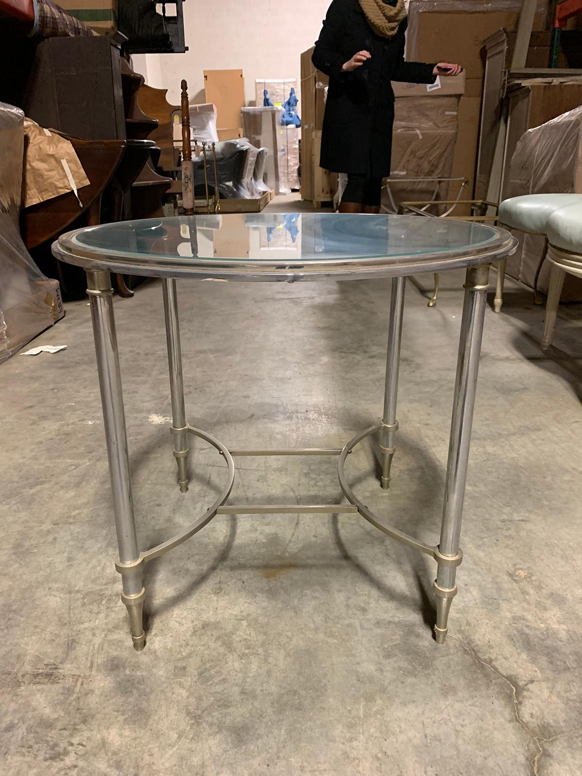 20th century round steel and glass table attributed to Maison Jansen.