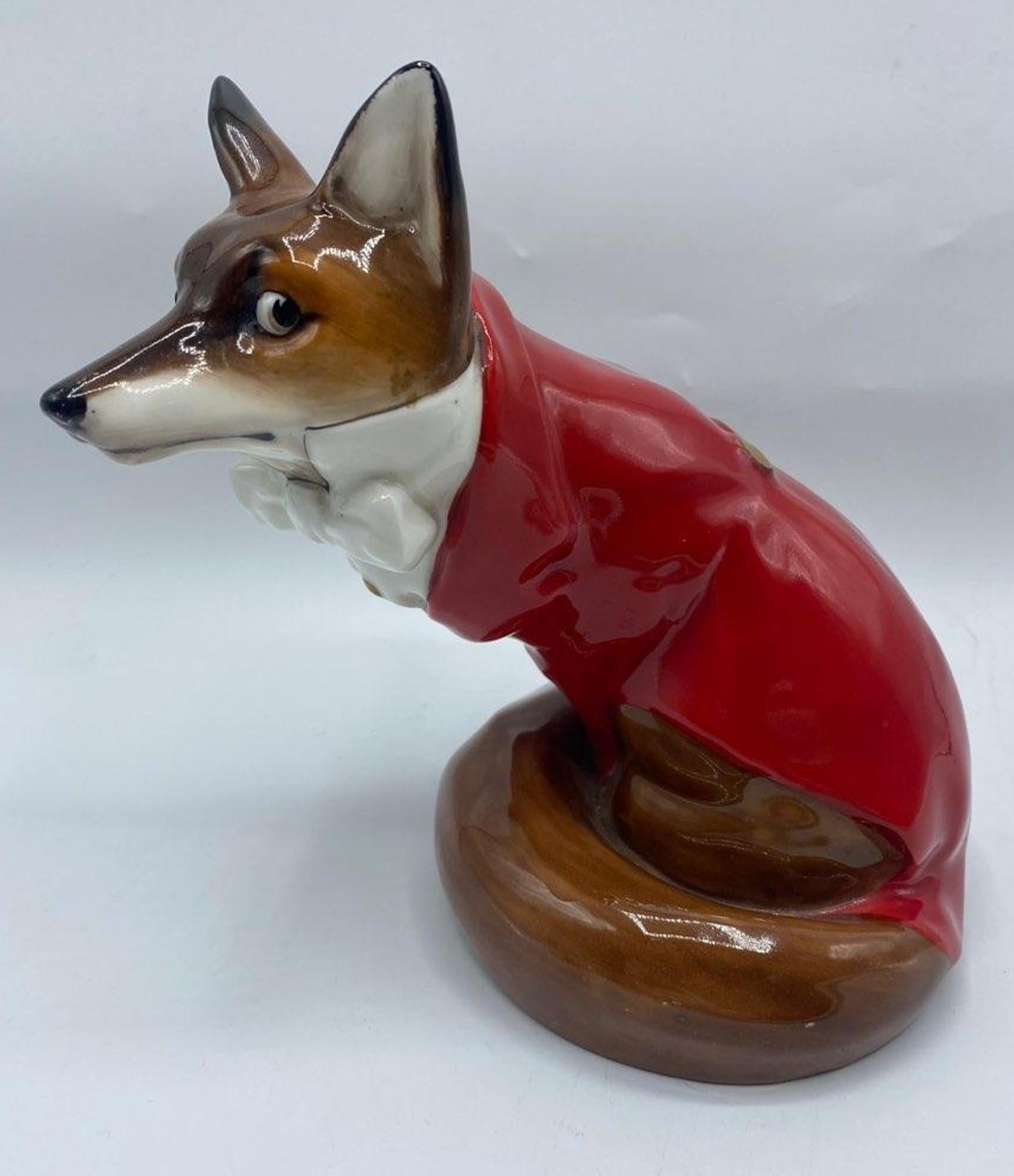 20th century Royal Daulton Fox in red hunting coat bone china figurine
Modeled seating in hunting dress - hunting coat, white shirt and bow tie
Printed mark - 