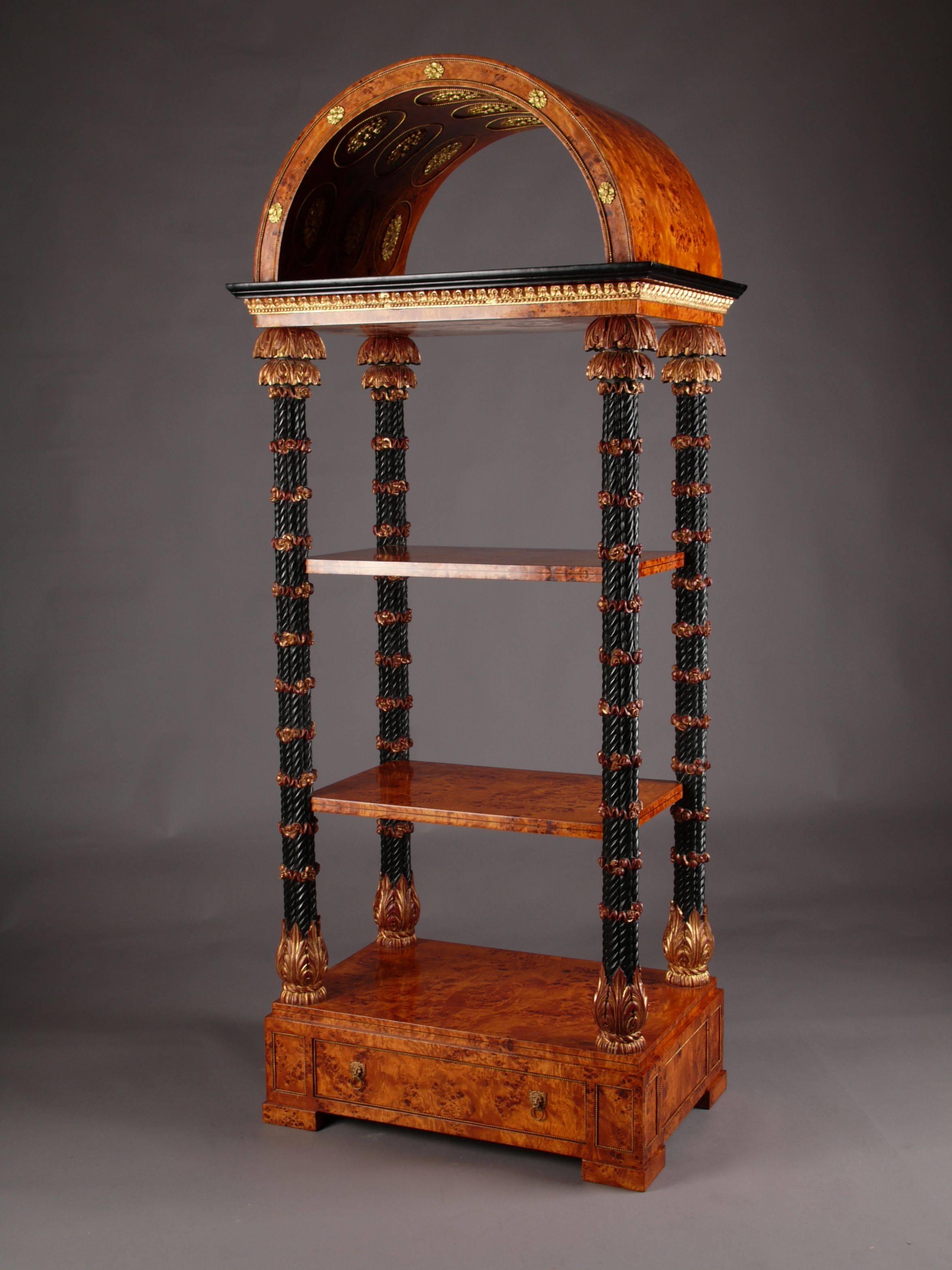 Aristocratic étagère in Royal-Donau style.
Maple root and solid fully moulded carved beechwood. Partially gilded. Highly, right-angled body, architecturally structured body with two shelf boards and edging gallery in the form of a balustrade ending