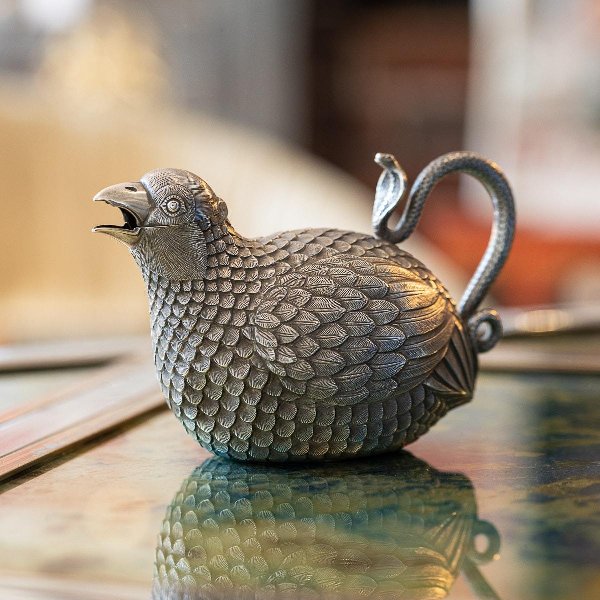 Antique early 20th century Indian cutch solid silver cream jug, modeled as seated, well-rounded quail, realistically decorated with detailed feathers and richly gilded interior. The head hinging open along the beak to serve as the spout and the