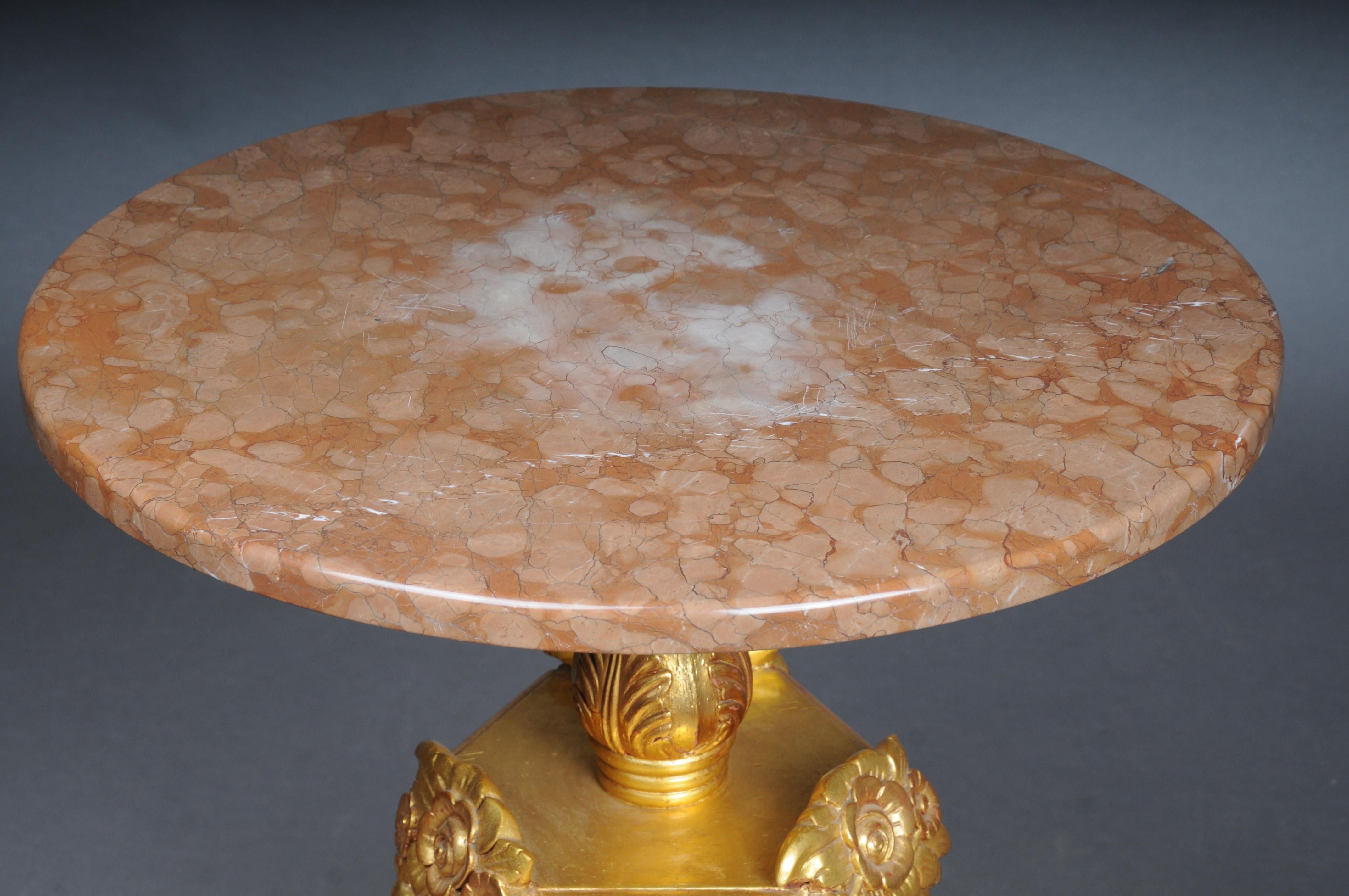 20th Century Royal ornate side table gilded with marble top

Rich ornate ceremonial table, wood, carved and gilded. Round marble slab on baluster with predatory heads and garlands
Corpus shaft flanked by three mythical creatures connected with