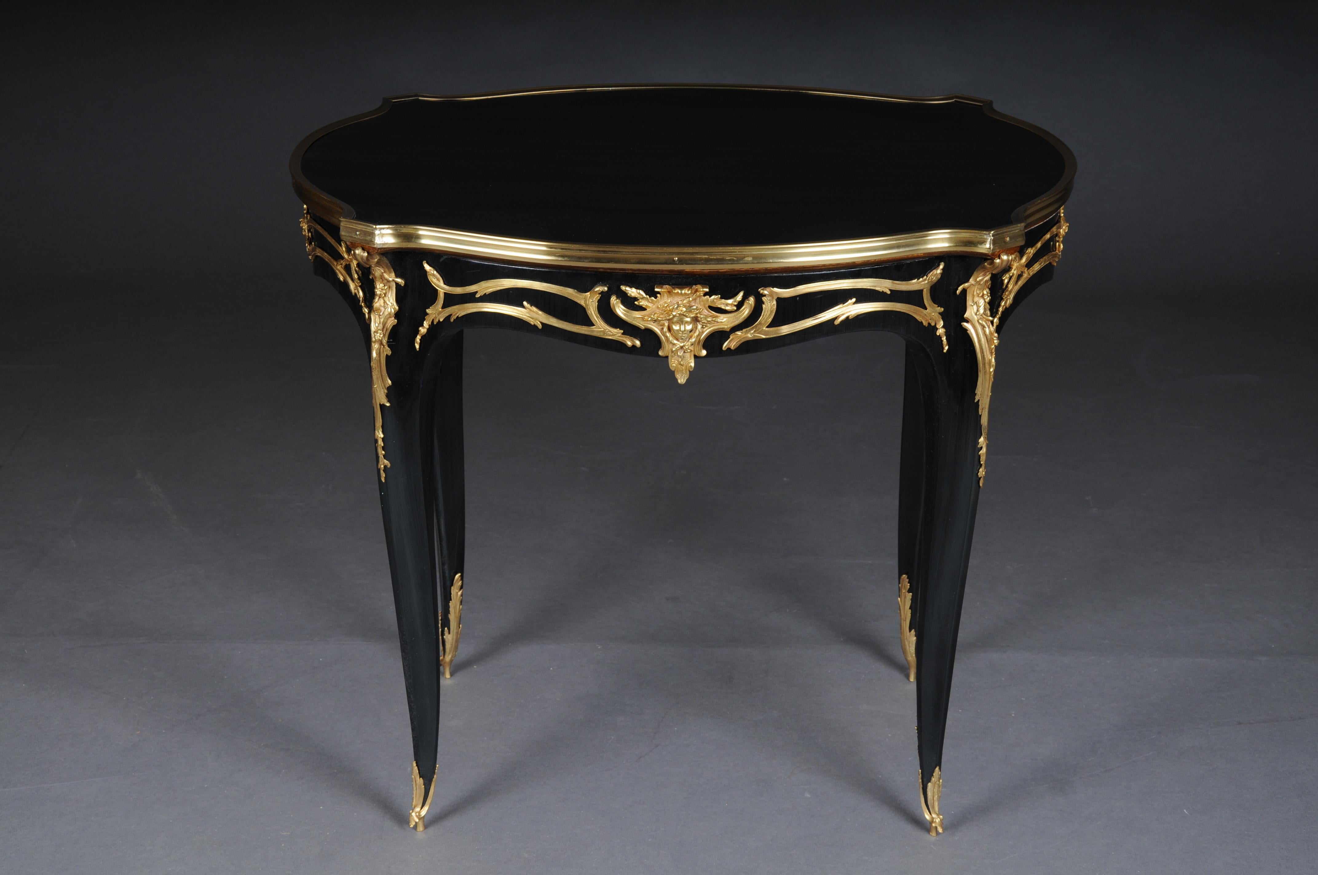 20th Century royal side table after Francois Linke, Paris, black gold

Majestic side table with extremely finely chased and gold-plated bronze fittings. Slightly convex and concave curved body, flanked by extended corner pilasters on high,