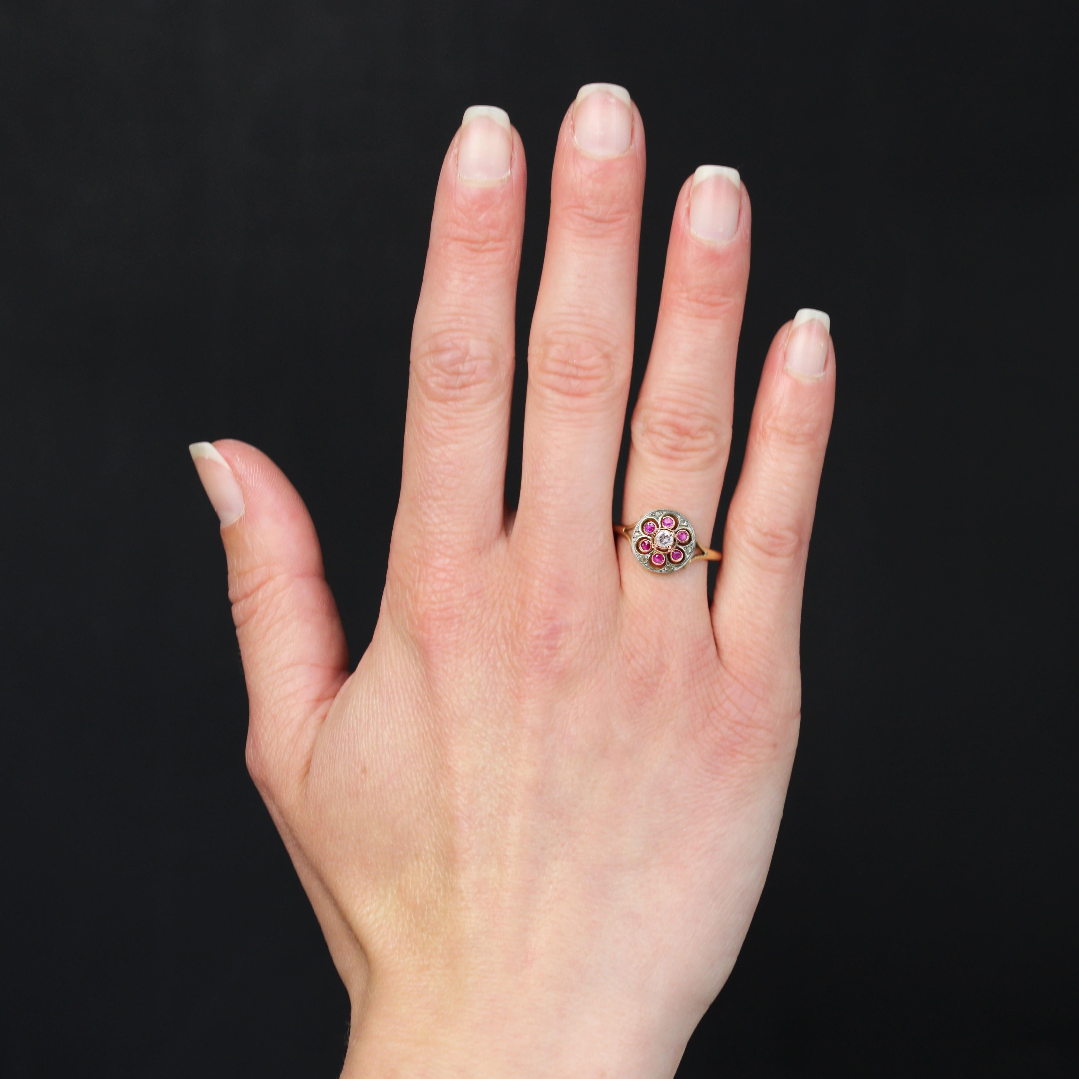 Ring in 18 karat yellow gold and platinum.
A charming round antique ring with openwork setting, set in platinum with rose-cut diamonds and in yellow gold with 6 rubies in closed setting and a brilliant-cut diamond in the center, held in place by 4