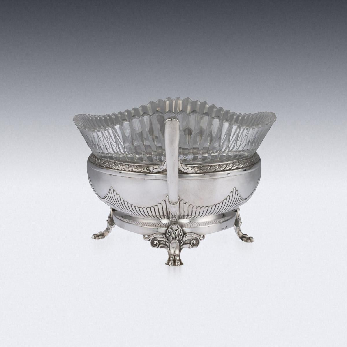 Antique early 20th century Russian empire style solid silver and cut glass jardinière, oval shaped and mounted with geometrical twin handles, boarders embellished with laurel leaves and half fluted design along the base, standing on four leaf capped