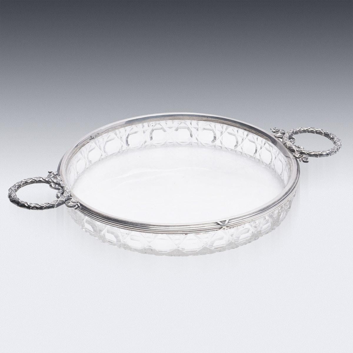 Antique early-20th century Russian Empire style Faberge solid silver & cut glass dish, round shaped and mounted with wreath twin handles, embellished with interwoven boarders, reeds along the rim, set with a Russian cut glass bowl. Hallmarked