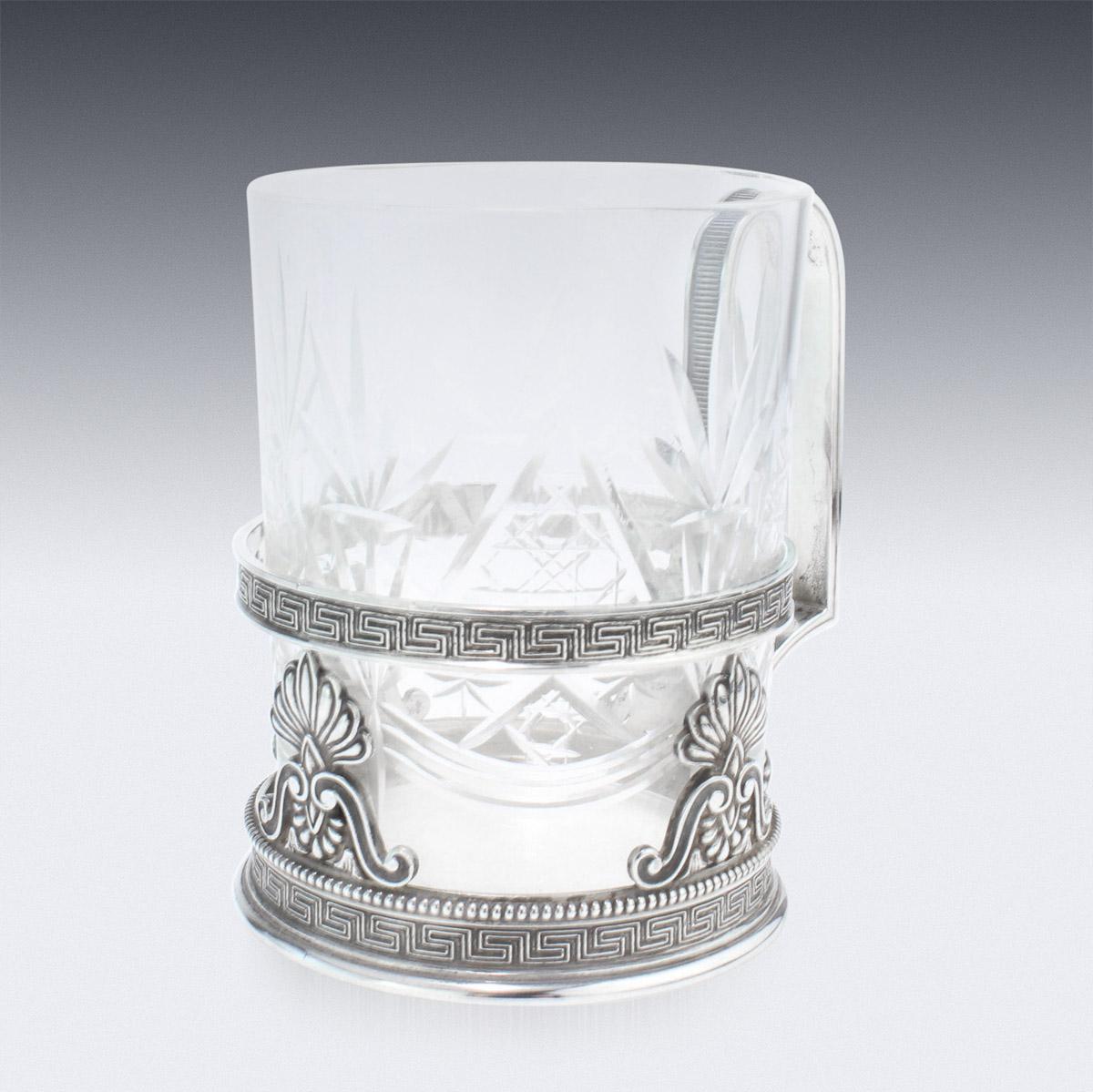 Antique early-20th century Russian Faberge solid silver tea glass holder, made in Imperial style, with Grecian cross-key and beaded boarders, applied with a solid arching scroll handle, and fitted with cut glass cup. Hallmarked silver 84 (875