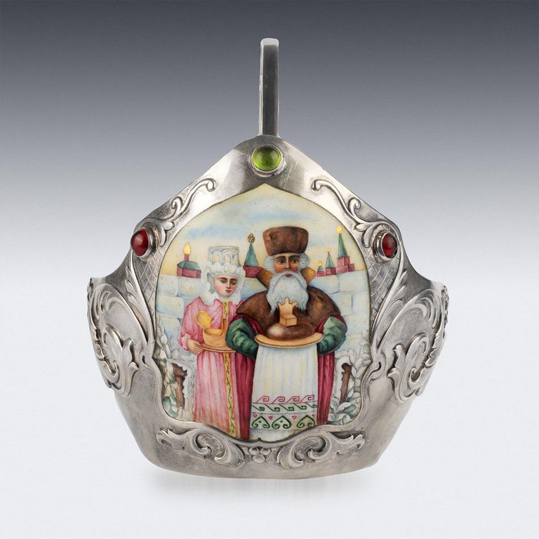 Antique early 20th century Imperial Russian solid silver, gem set and hand painted enamel kovsh, sides applied with emeralds and rubies cabochons, with a shaped elongated handle, the body chased with traditional Pan-Slavic floral decoration and the