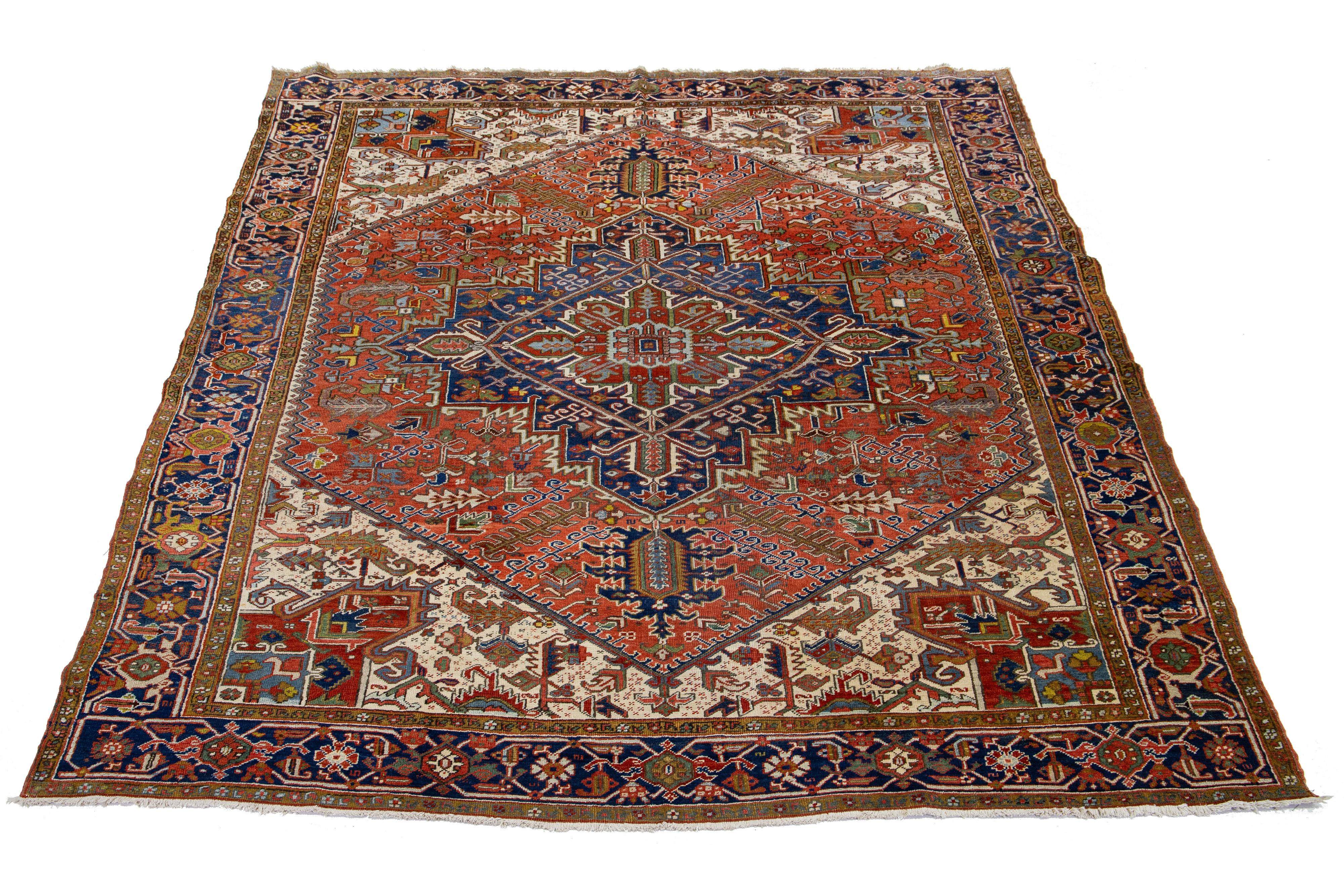 Beautiful vintage Persian Heriz rug with a red-rust field. This rug showcases a medallion design in the center, along with multicolored accents. 

This rug measures 9'5