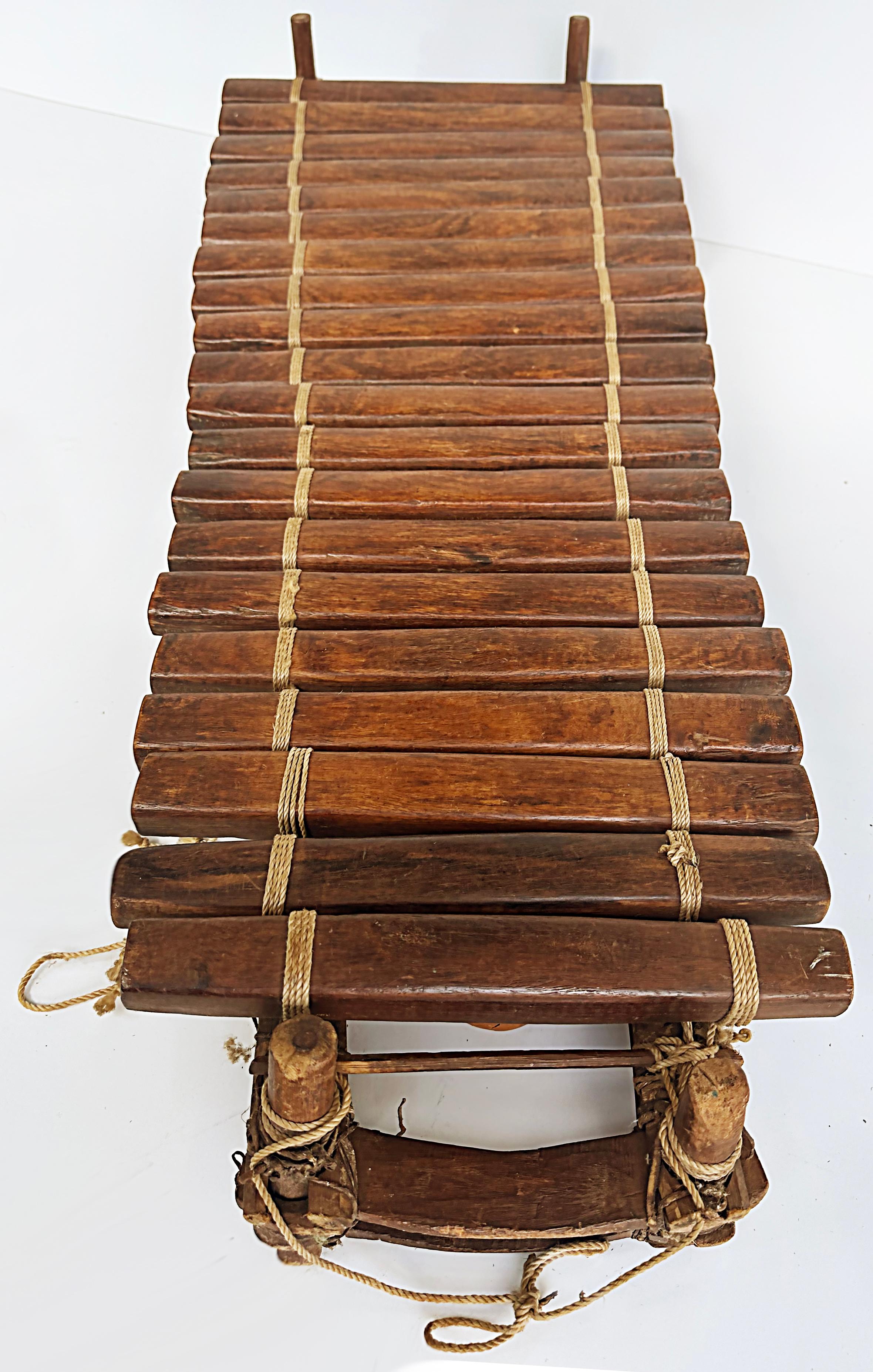 20th century Rustic African Xylophone with Wood, Gourds, Rope, and Mallets

Offered for sale is a 20th century rustic African xylophone with wood, gourds, rope, and mallets. The wood xylophone is assembled with rope and gourds. It has two mallets