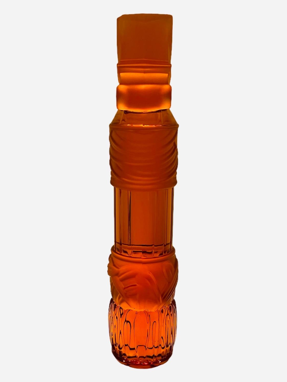 This is a limited edition Saint Louis Cut Crystal “Le Lotus” Totem. It depicts a clear and frosted amber crystal tall cylindrical totem decorated with a finial made of a rectangular block with four leaves with some scrolls under it.  Below that, the