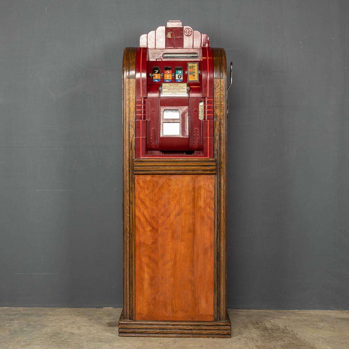 Antique early-20th Century “Totalisator” slot machine made in cast iron and housed in an oak cabinet. This machine works using old pennies and is made in the USA by Mills Novelty Co of Chicago and distributed all over Europe by the Samson Novelty