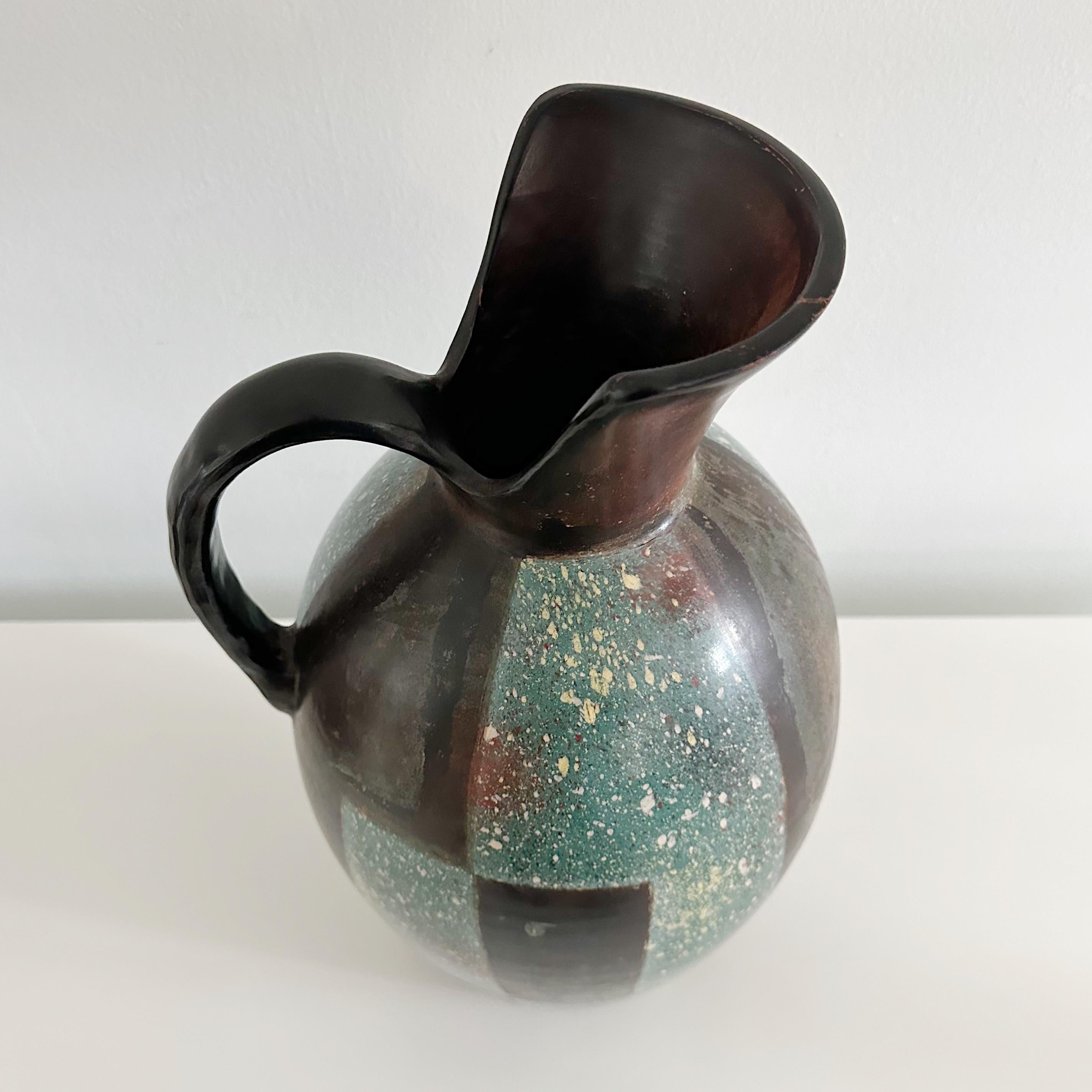 20th Century Santodio Paz Chulucanas Peru Ceramic pitcher. Handcrafted in the Andes mountains of Peru. Teal and brown hues with a unique painted design. Originating from ancient Tallan and Vicus cultures, featuring the technique of 
