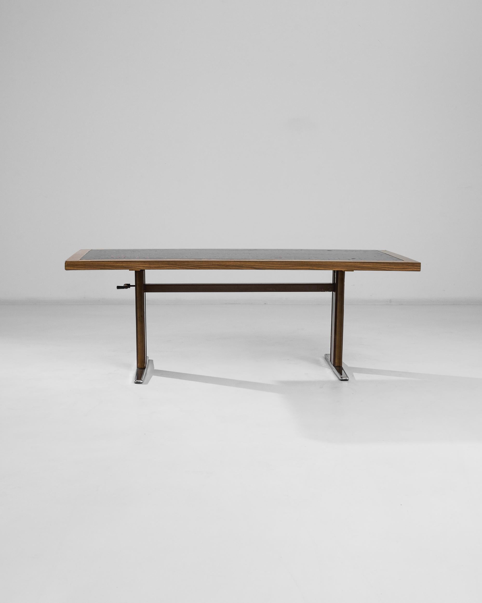 This 20th Century Scandinavian Metal Coffee Table seamlessly blends the natural warmth of a wooden top with the sleek, industrial feel of a metal base. The tabletop showcases a rich, wood grain texture, bordered by a unique inset that features a