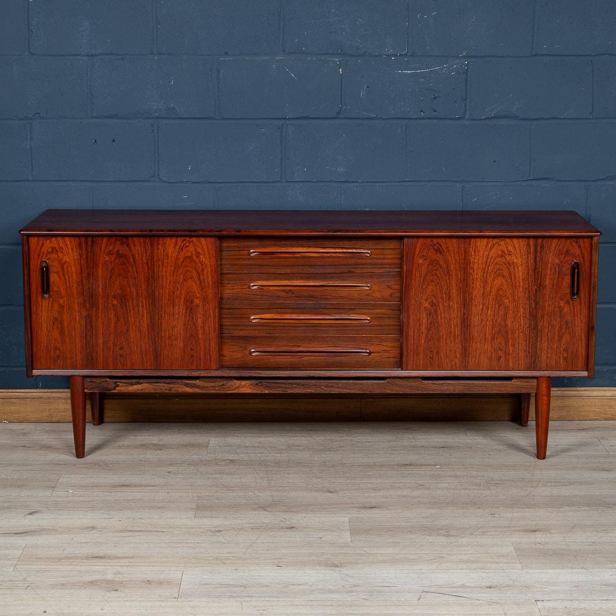 A rare vintage Swedish rosewood sideboard designed by the talented Nils Jonsson for Troeds in the 1960s. The 'Trento' model boasts a stunning rich exterior made from solid and veneer rosewood and features clean architectural lines, recessed handles
