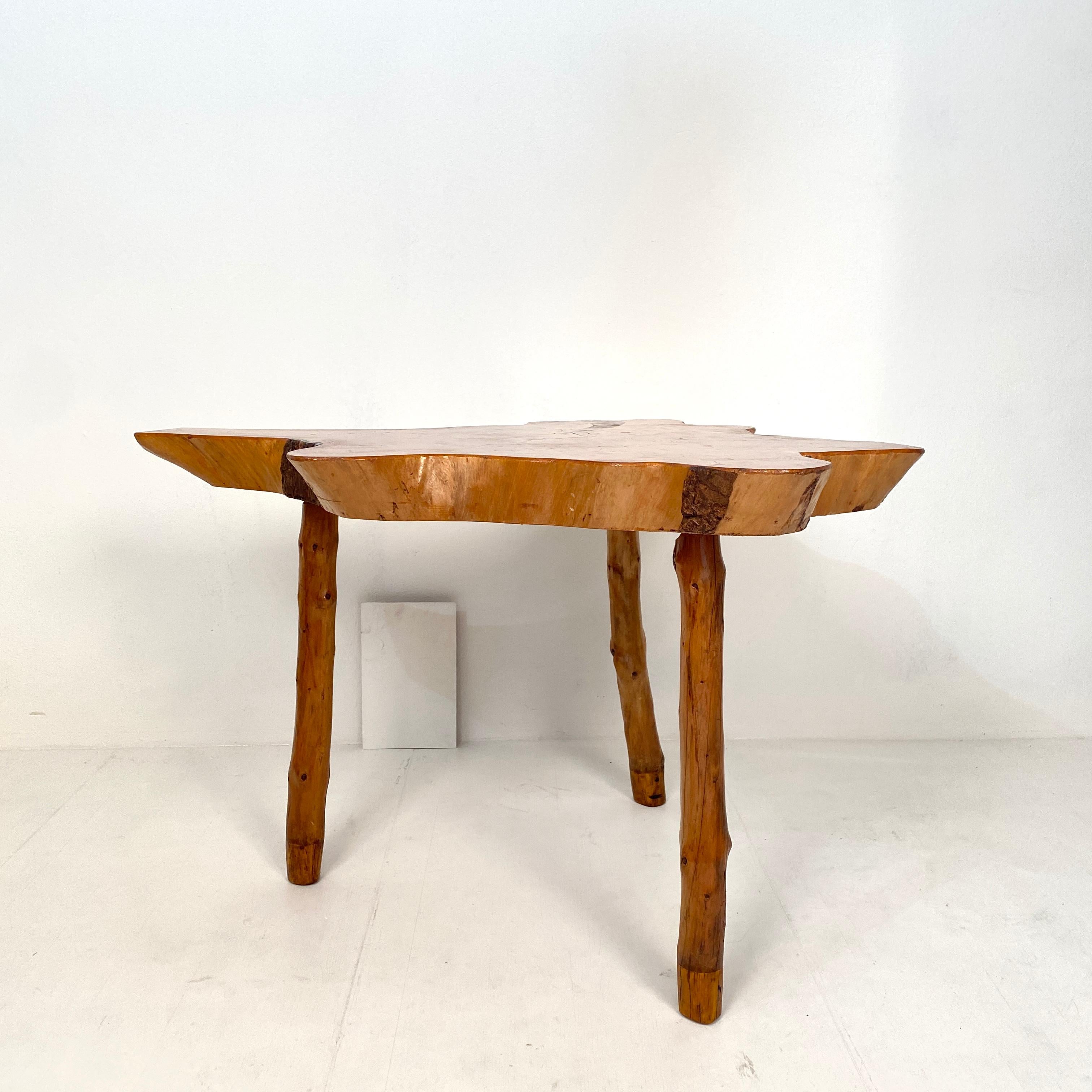 This beautiful 20th century primitive Scandinavian tree trunk table was made circa 1920.
It can be used as centre table, writing desk or dining table.
The table top has got a great shape and the it has got three legs, which have got repairs on the