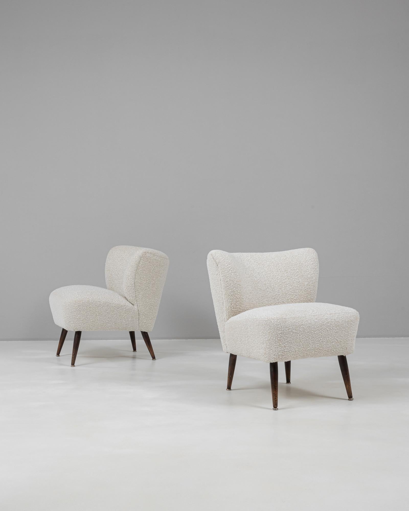 Esta pareja de sillas tapizadas escandinavas del siglo XX desprende un refinado encanto minimalista, sinónimo del diseño nórdico de mediados de siglo. Las sillas presentan respaldos suavemente curvados y asientos generosamente acolchados, que