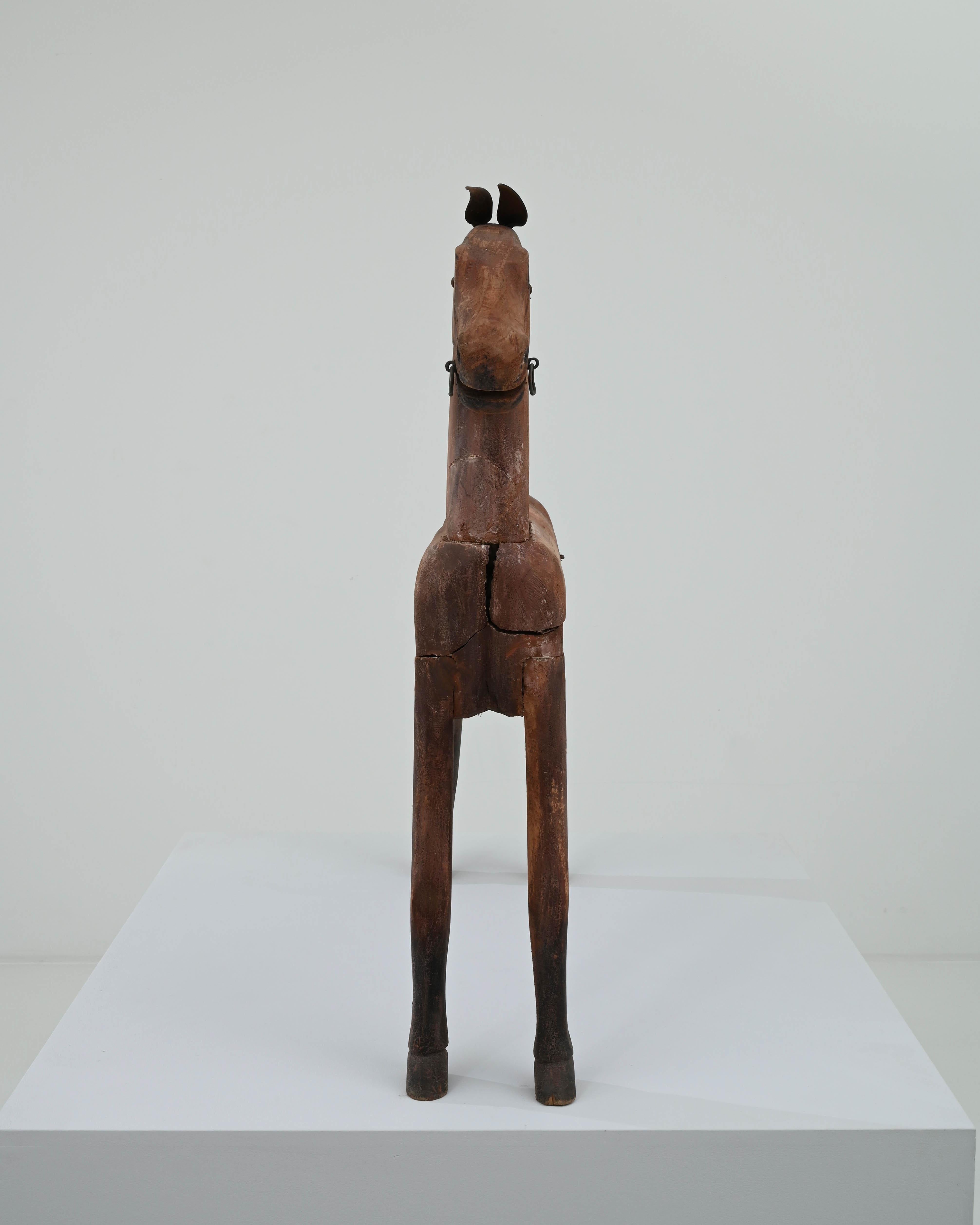 Likely intended as a children’s toy, this vintage wooden horse has a beautiful sculptural quality. Made in Scandinavia in the 20th century, the rough joints of the form give it a rustic character, while the graceful contours of the legs and
