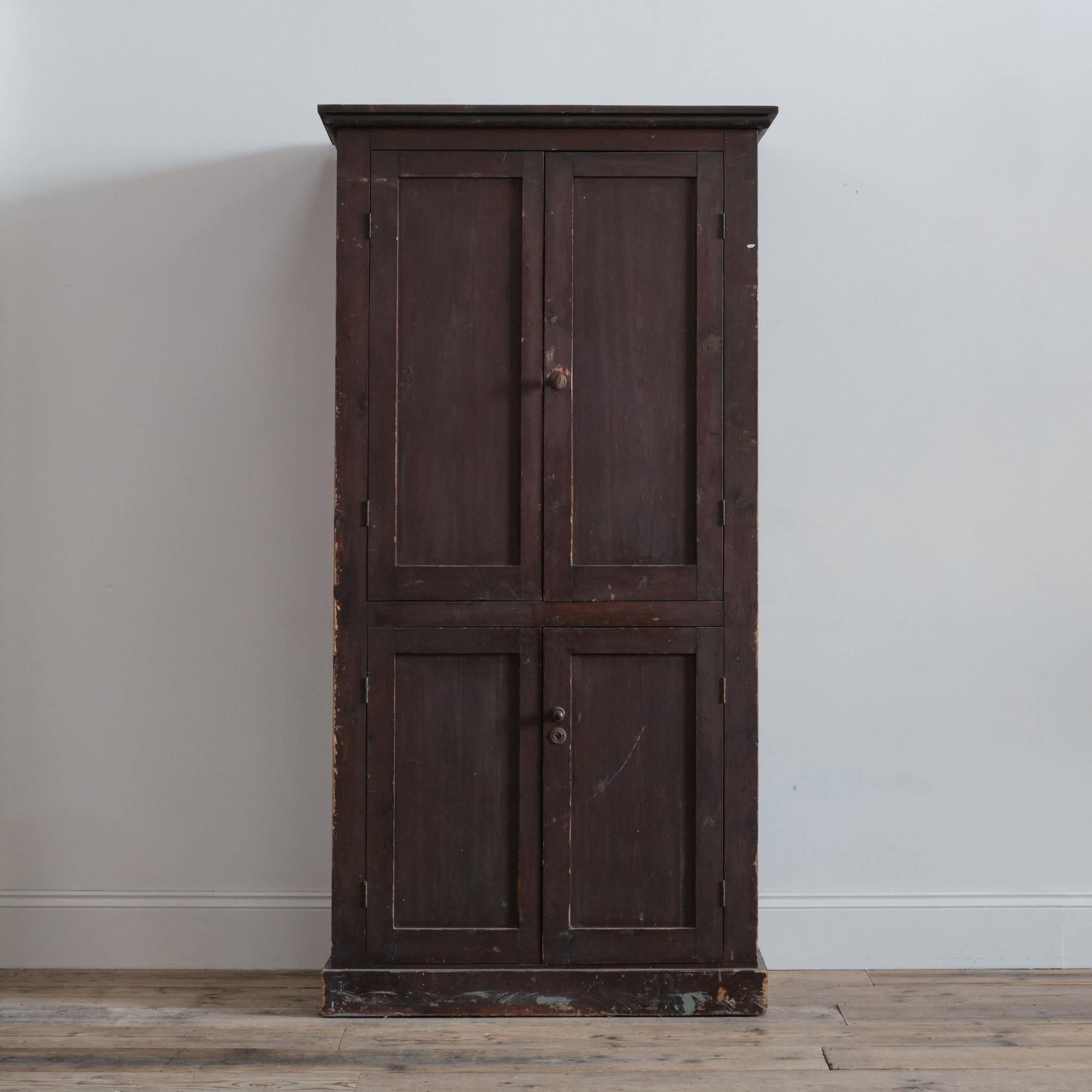 A 20th century pine kitchen cupboard with a nice dry patina and colour. Built from what appears to be reclaimed European crating materials. C1930 

The panelled doors with odd hardware open to reveal a shelved interior with 30cm distance between