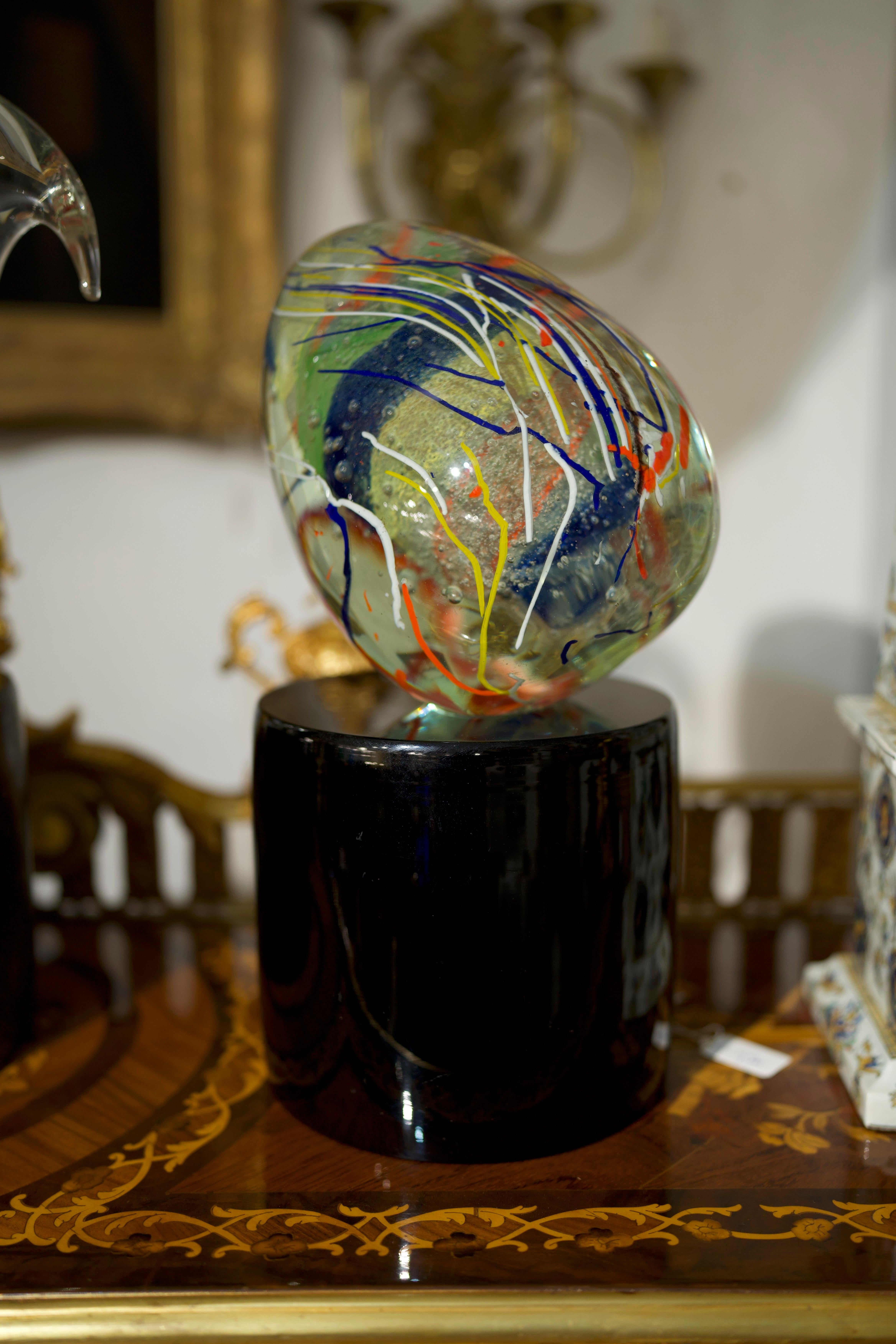 A unique 20th Century Sculptural Murano Glass Egg On Bronze Base. 
The shape is unusual: ovoid and angled; the mouth blown execution is extraordinary. The very innovative decoration is achieved with a sophisticated multicolour overlaid in clear