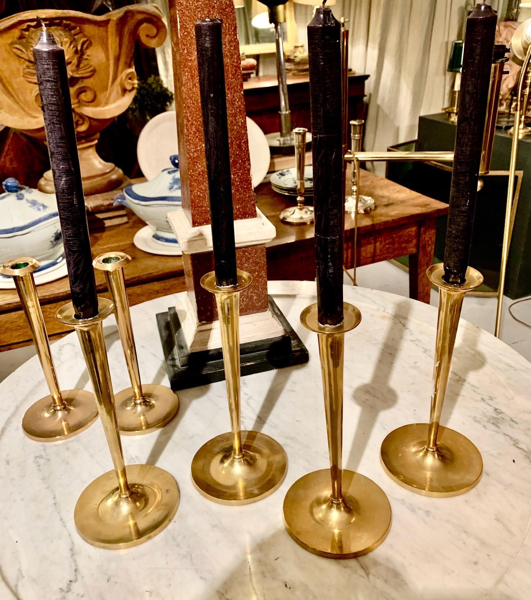 Set of four brass candlesticks, can be sold as a set of two or all four, trumpet-shaped design.
​
