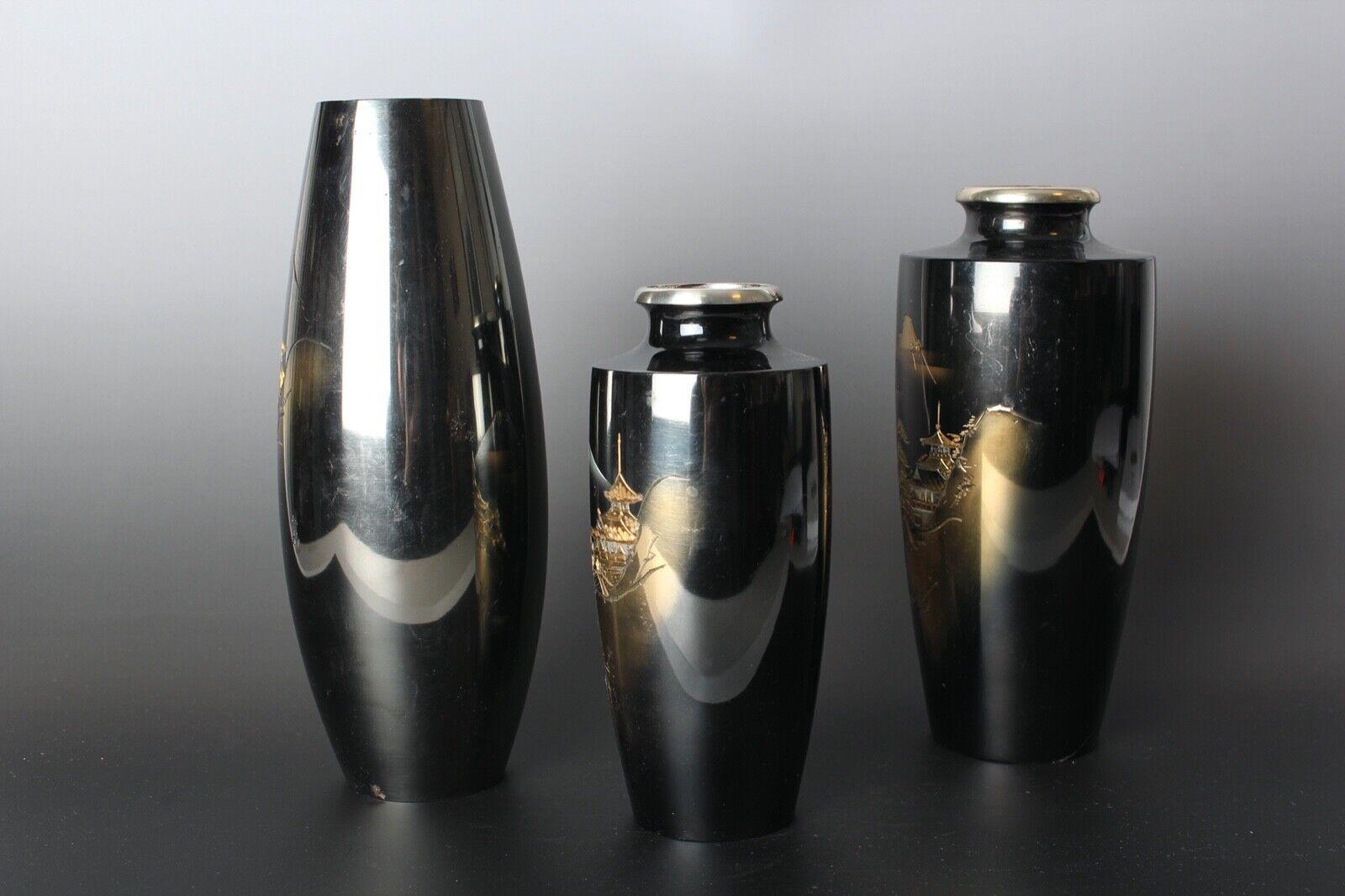 Stunning set of 3 copper metal vases with gorgeous dark plating, incised gold design. Dimensions: tallest vase - w.9cm (3.5 inches), h.25cm (9.8 inches); smallest vase - w.18cm (7 inches), h.7.5cm (2.9 inches). Total weight: 1.8kg (3.9 lbs). Some