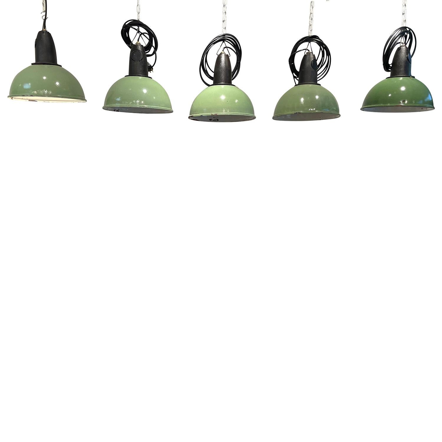 A vintage French Industrial similar set of five green ceiling lights, lamps made of hand crafted metal, in good condition. Each of the round pendants contain a single light socket. The wires have been renewed. Minor fading, due to age. Wear
