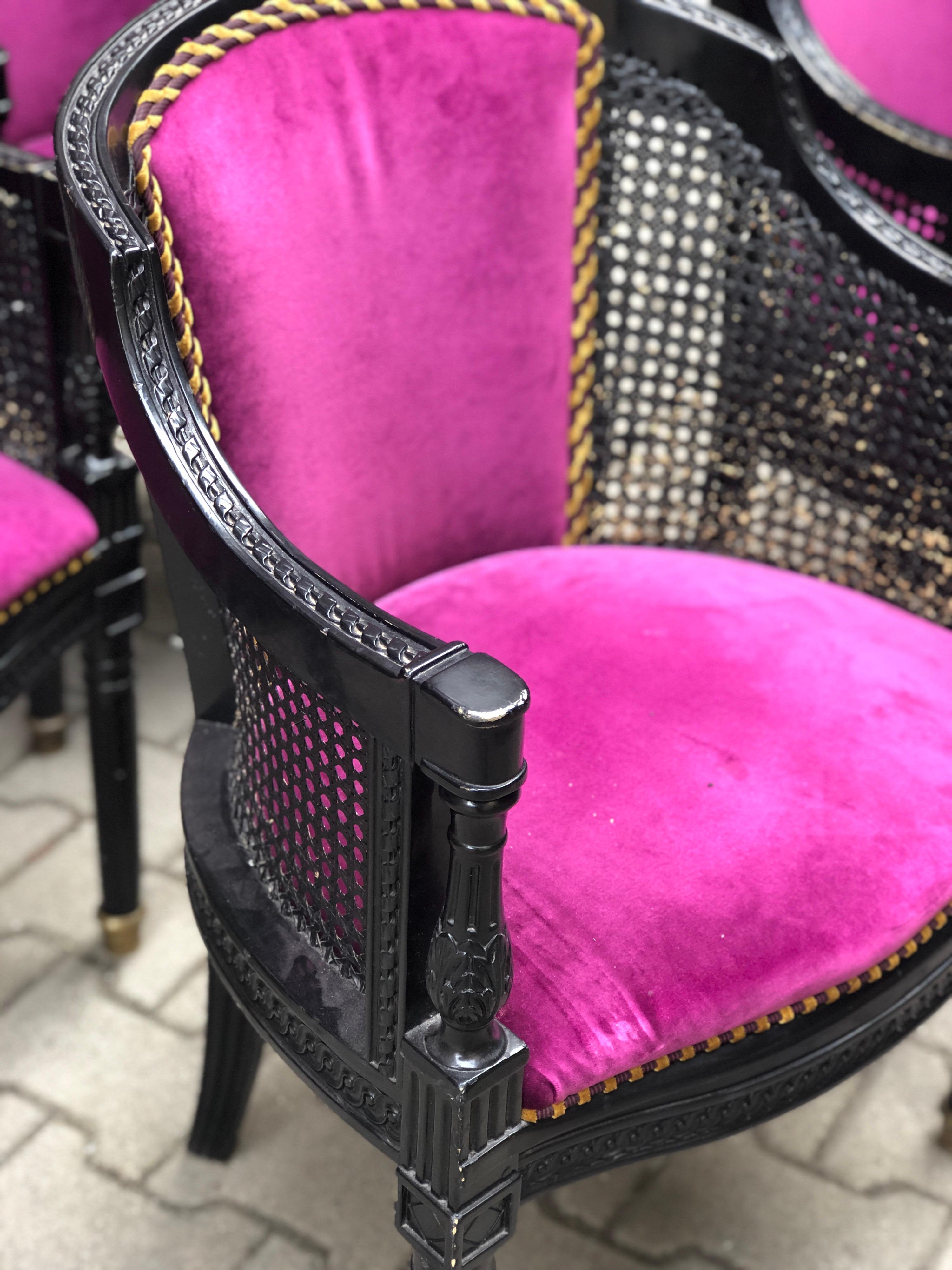 Set of four armchairs made in black massive wooden frame and original cane on the sides. The upholstery is in provocative purple velvet.
France, circa 1920.