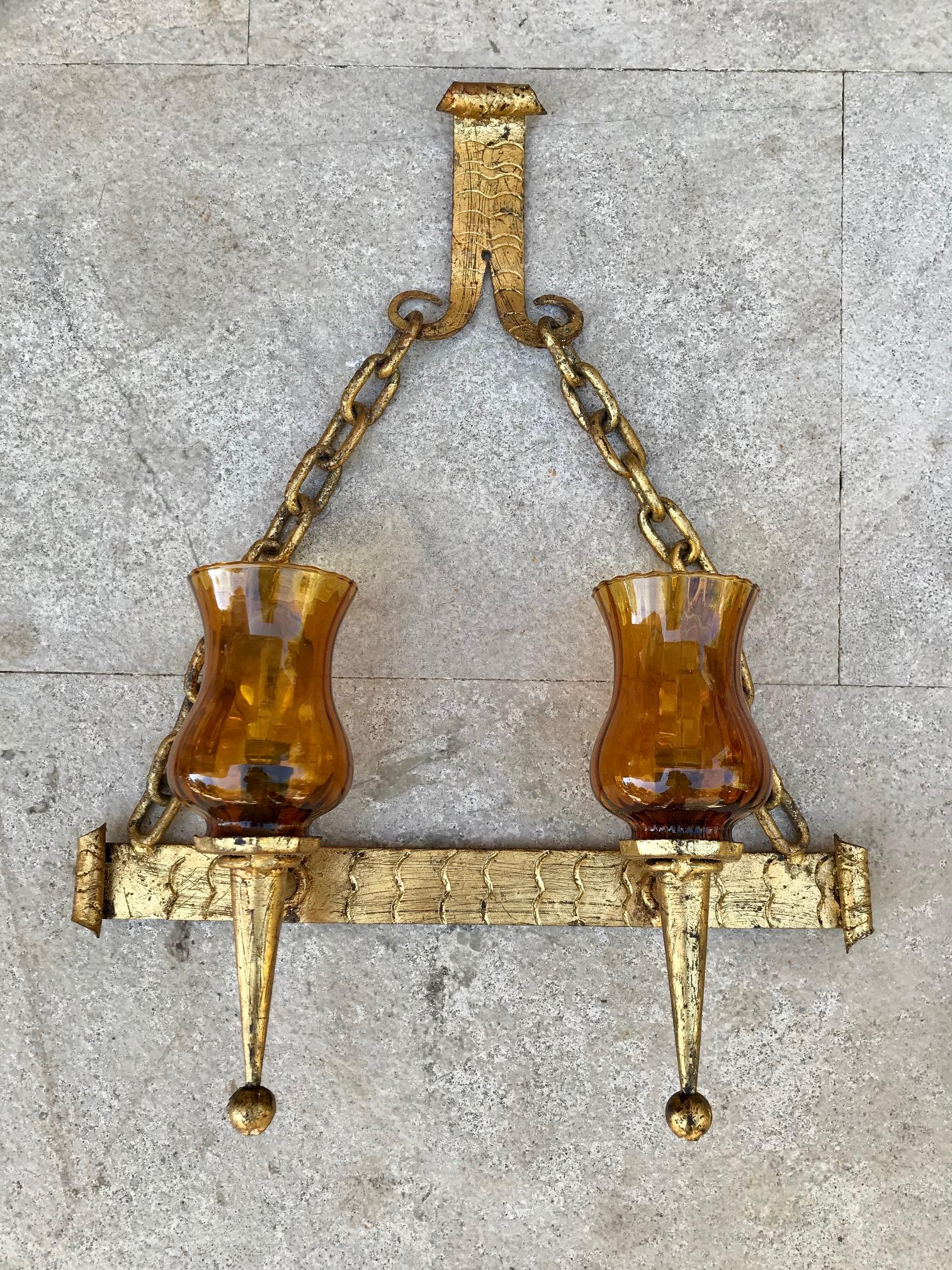 20th century set of French decorative gilt wrought iron sconces with glass shadows.

Measures: Pair sconces: W 14.56in, D 4.72in, H 8.26in.
 