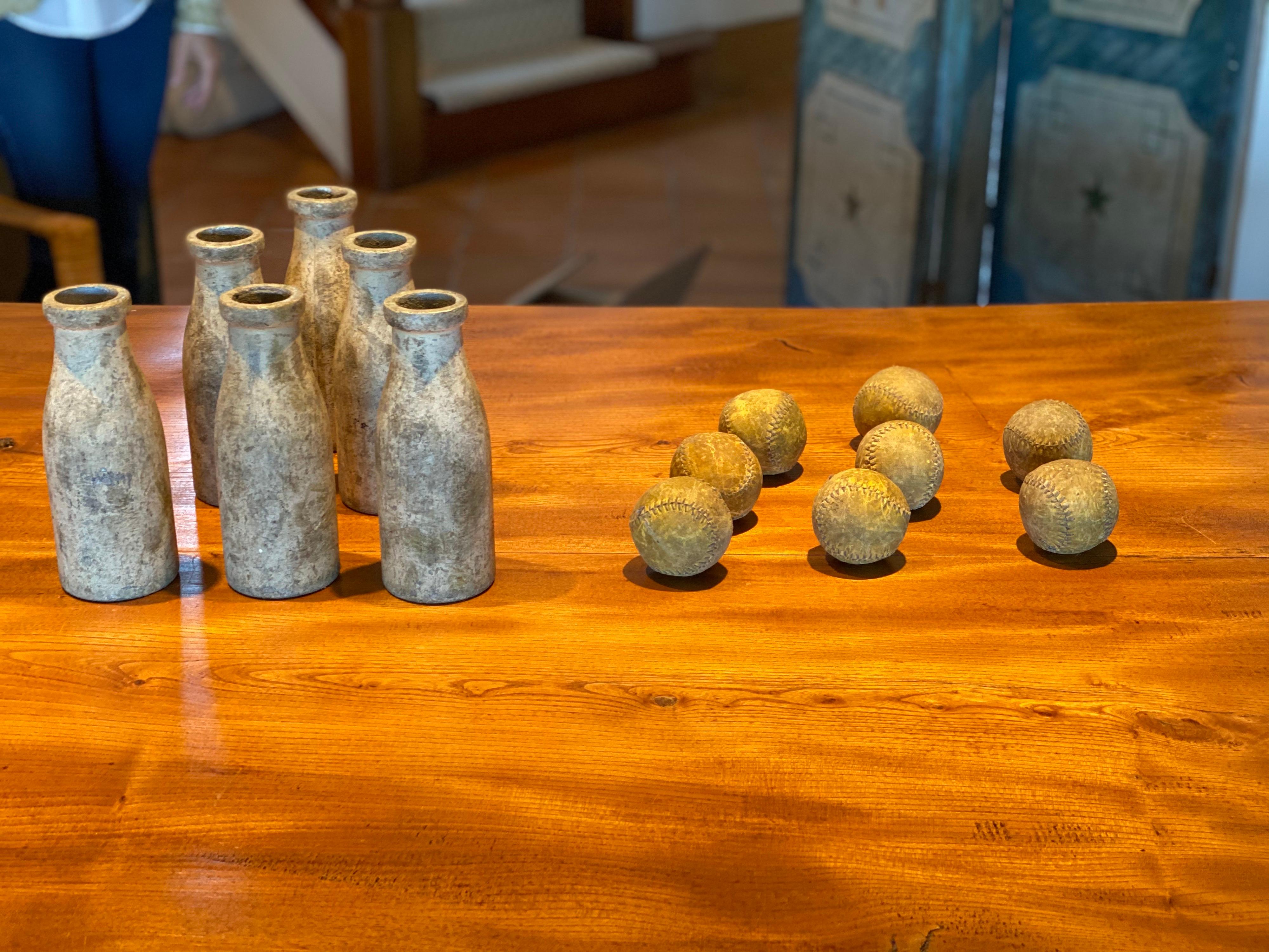 A set of six lawn bowling pins and six balls,
20th century
Pins molded in metal.
Overall fair condition, all well used

Measurements:
Pins x 6
Height 8 in
Width 3in

Balls x 8
Depth 2.5 in.