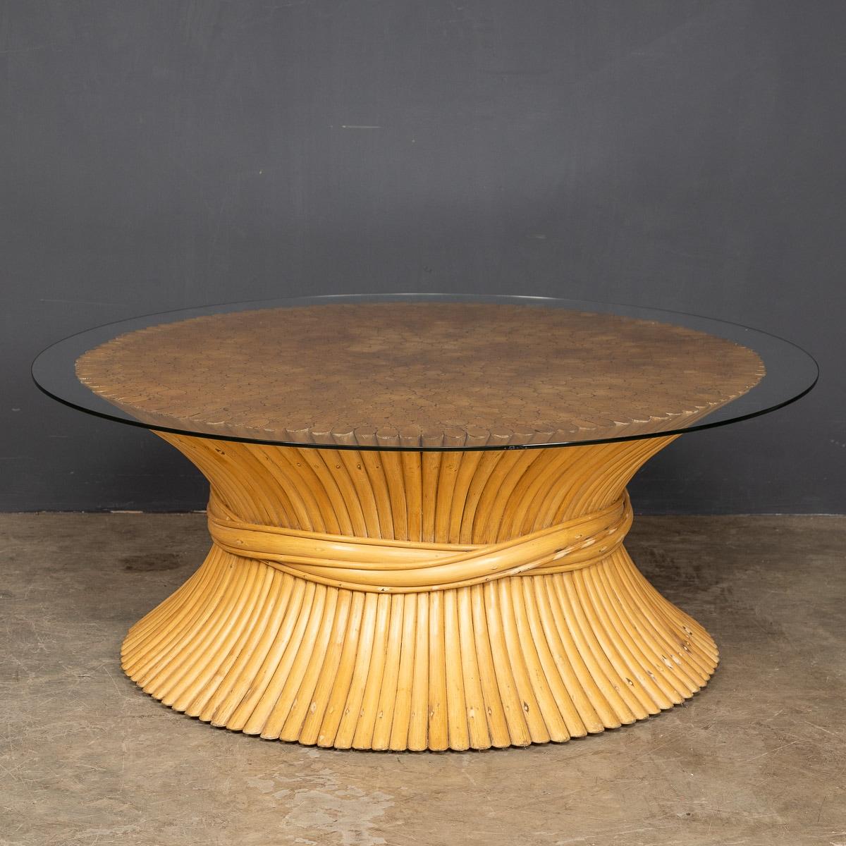 A good sized wheat sheaf coffee table by American designer John McGuire with the iconic bamboo base and glass top, c.1970s.

CONDITION
In Good Condition - wear consistent with age.

SIZE
Diameter: 103cm
Height: 42cm