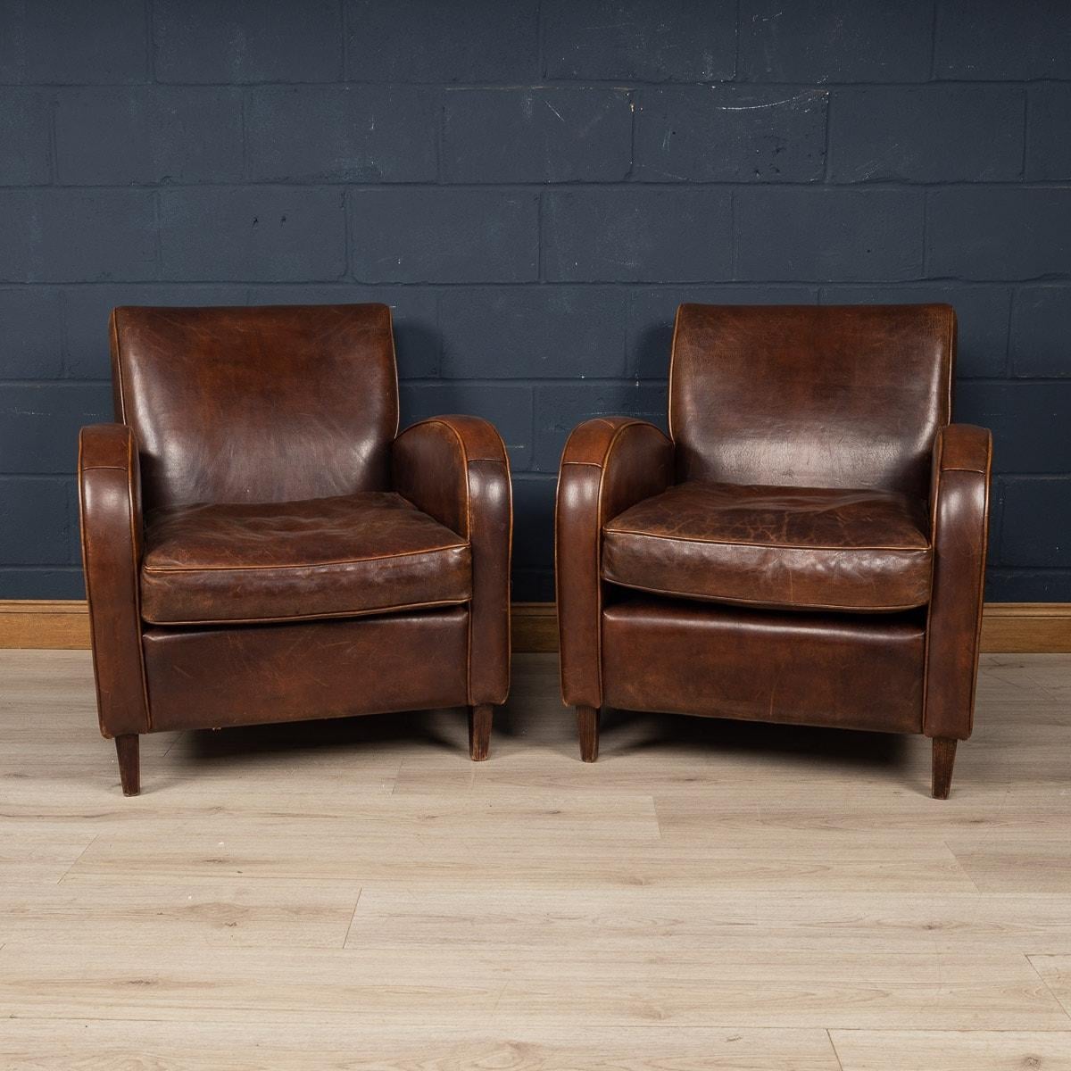 Showing superb patina and colour, this wonderful pair of club chairs were hand upholstered sheepskin leather in Holland by the finest craftsmen in the latter part of the 20th century.

CONDITION
In Good Condition: some wear consistent with normal