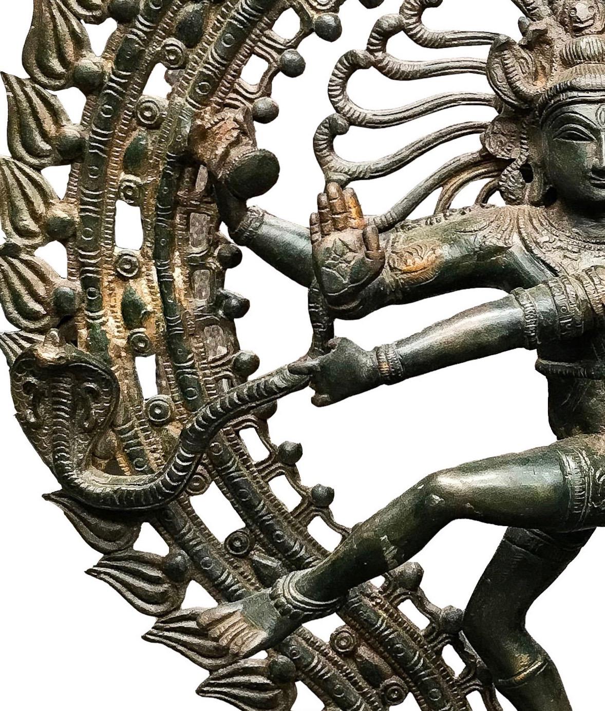The figure of God Shiva, creator god, preserver and destroyer of the world, in his attitude of Natarasha, also known as the lord of the cosmic dance. This dancing piece is standing on a lotus flower which symbolize the waters from where a dwarf