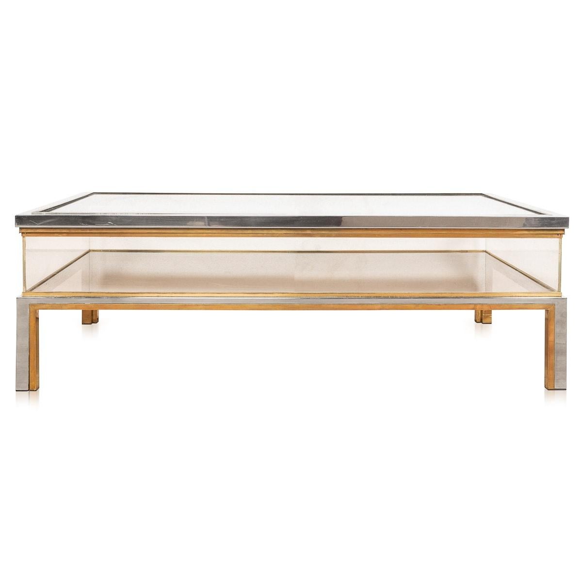 A lovely “showcase“ coffee table made by Romeo Rega, Italy, circa 1970. The chrome and brass structure supporting two large glass shelves, this style of table is known as a “vitrine“ (or showcase) coffee table and it is one of the more iconic