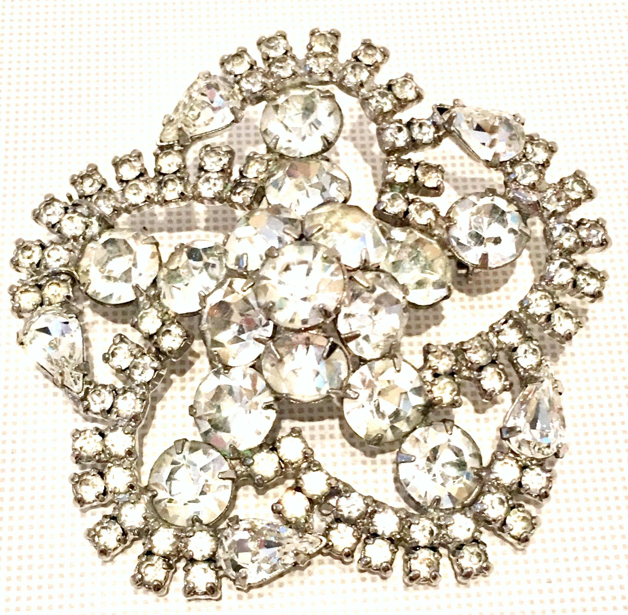 20th Century Silver  & Austrian Crystal Clear Rhinestone Brooch. This large dimensional and brilliant brooch features, silver chromium plate metal with prong set crystal rhinestones. The stones are round and pear shaped. The brooch has a dimensional
