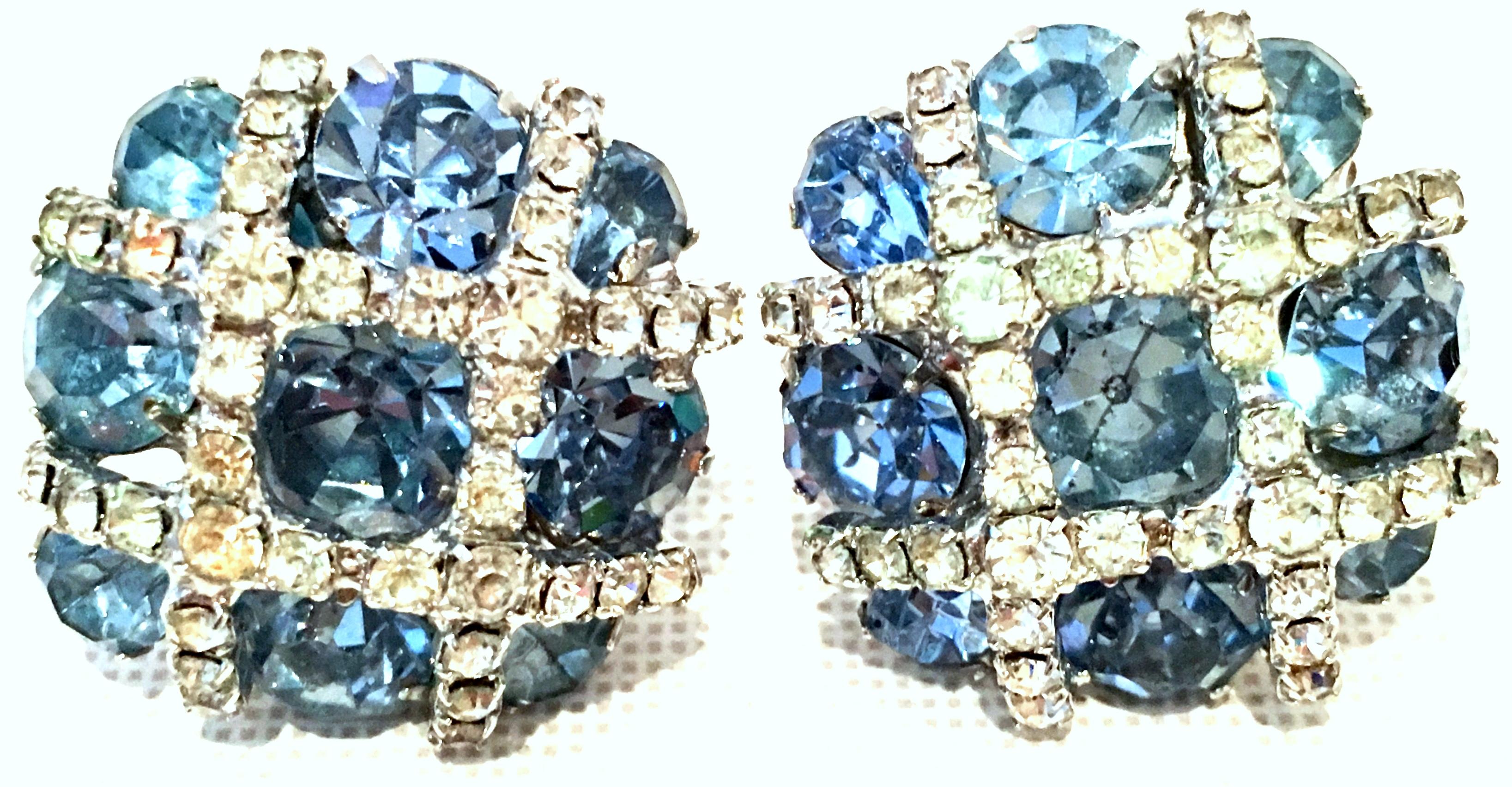 Mid-20th Century Pair Of Silver & Austrian Crystal Dimensional Earrings By, Kramer. These silver rhodium plate clip style earrings feature fancy prong set brilliant cut and faceted sapphire blue pear and round shaped stone. The applied silver criss