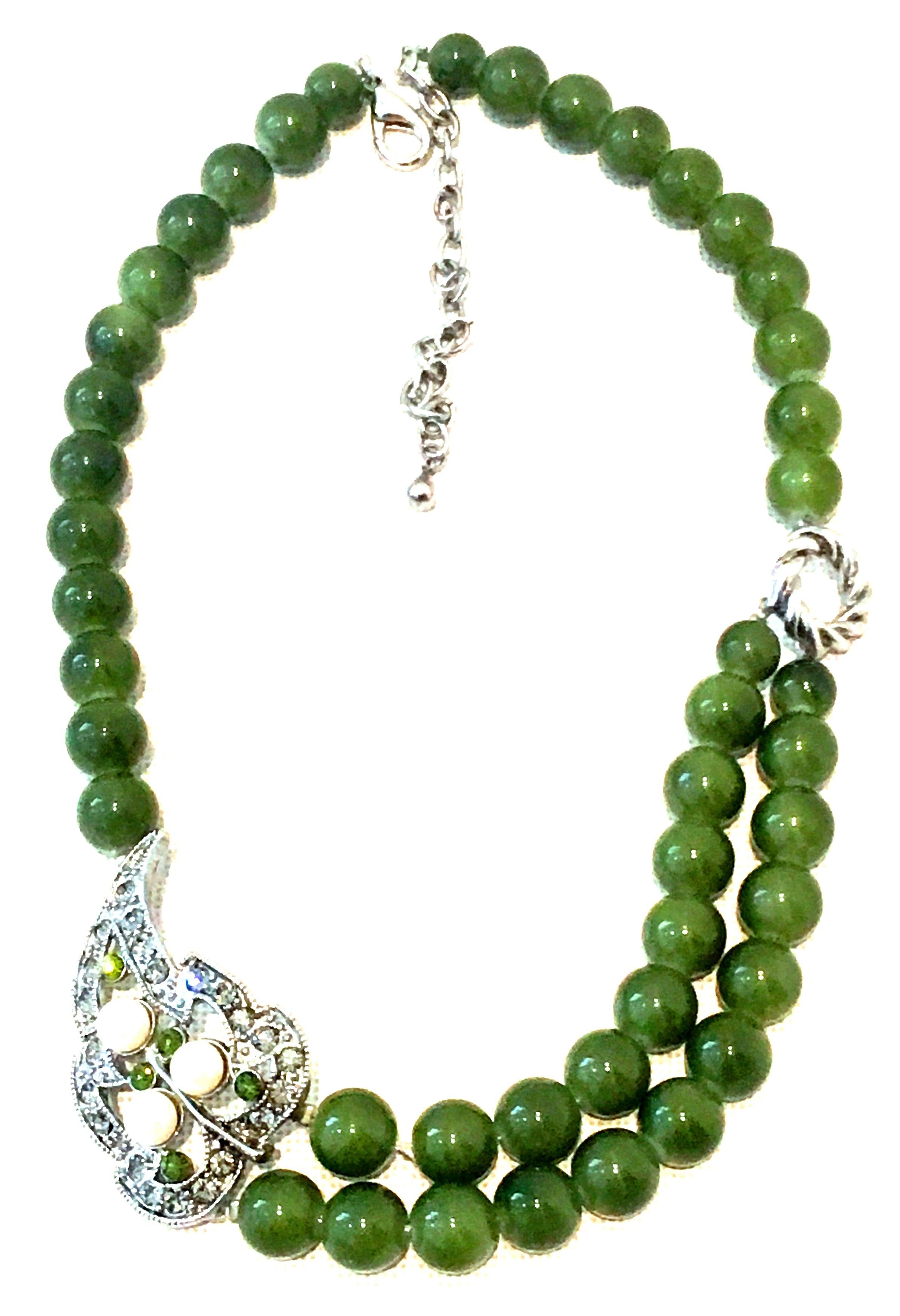 20th Century Silver, Austrian Crystal, Faux Pearl & Faux Jade Glass Bead Necklace. This choker style necklace features a central double strand of faux jade glass beads with an off center silver ornament. The ornament is curved with Austrian crystal