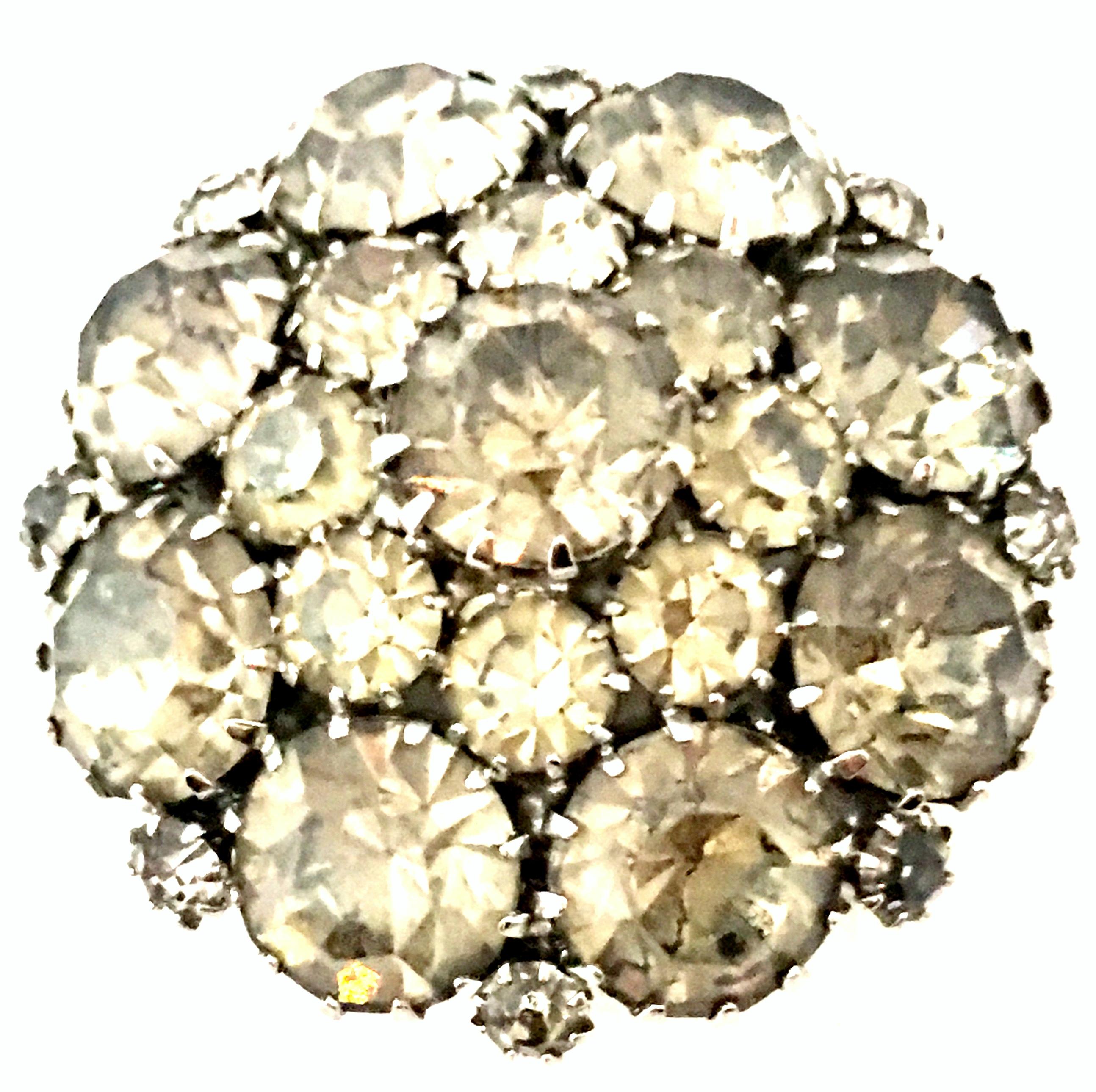 20th Century Silver & Austrian Crystal Schreiner Style Dimensional Dome Brooch. This Schreiner style silver rhodium plate dimensional dome brooch features fancy prong set brilliant cut and faceted smoky topazAustrian crystal stones.
The larger