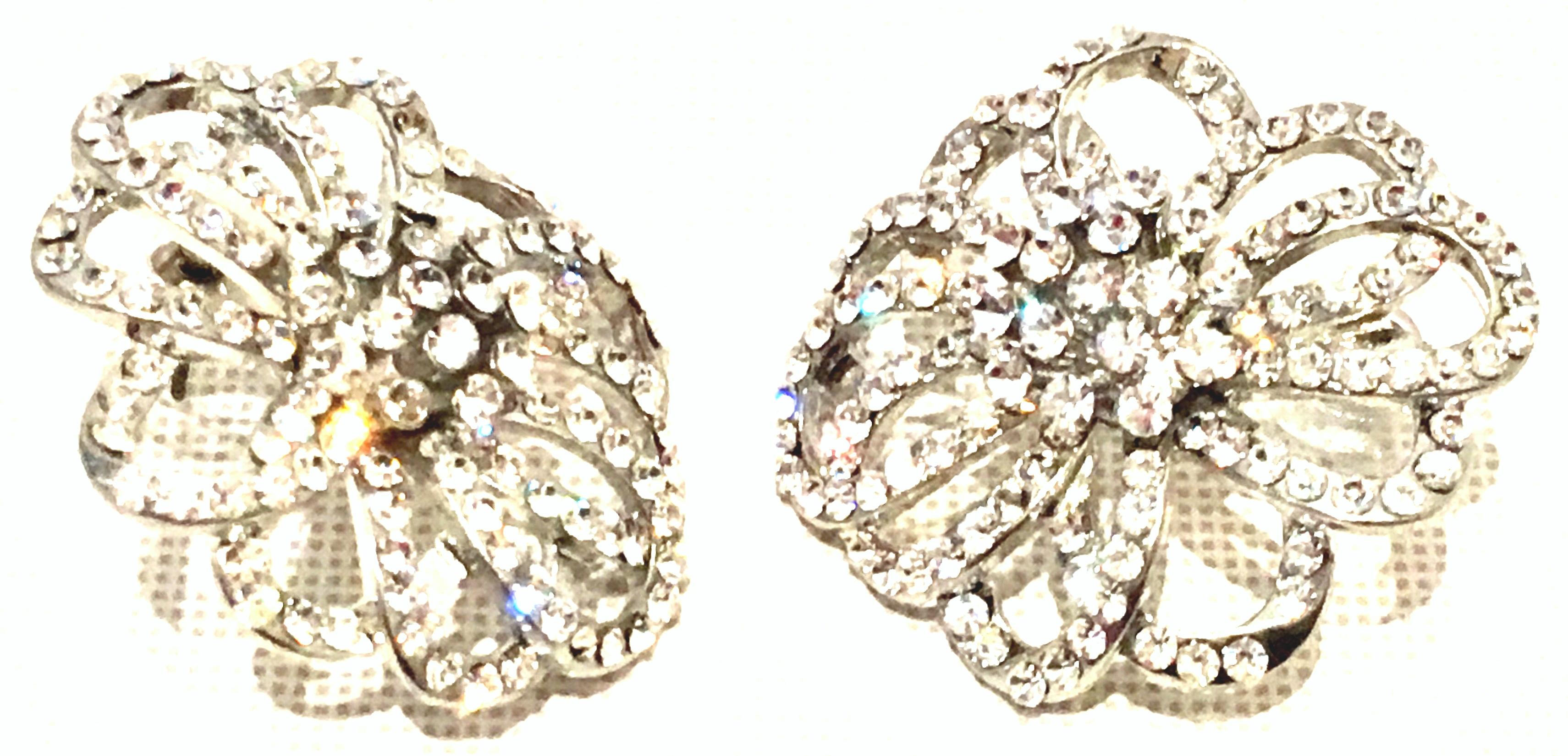 20th Century Silver & Austrian Crystal Abstract Dimensional Floral Earrings By, Swarovski. These pierced style earrings feature brilliant cut and faceted pave set stones with a silver rhodium plate base metal.